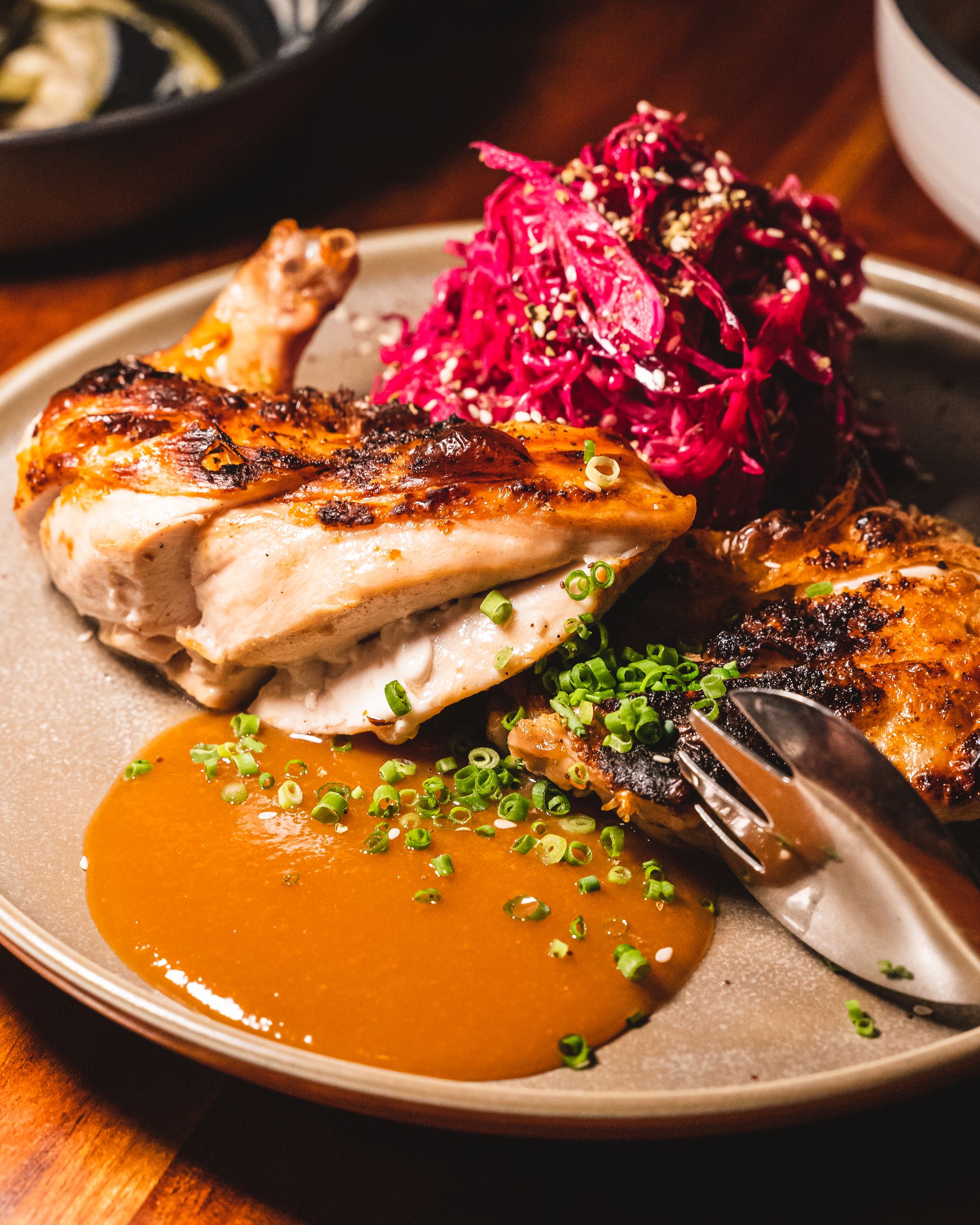 Close up of pan seared chicken, miso and red cabbage