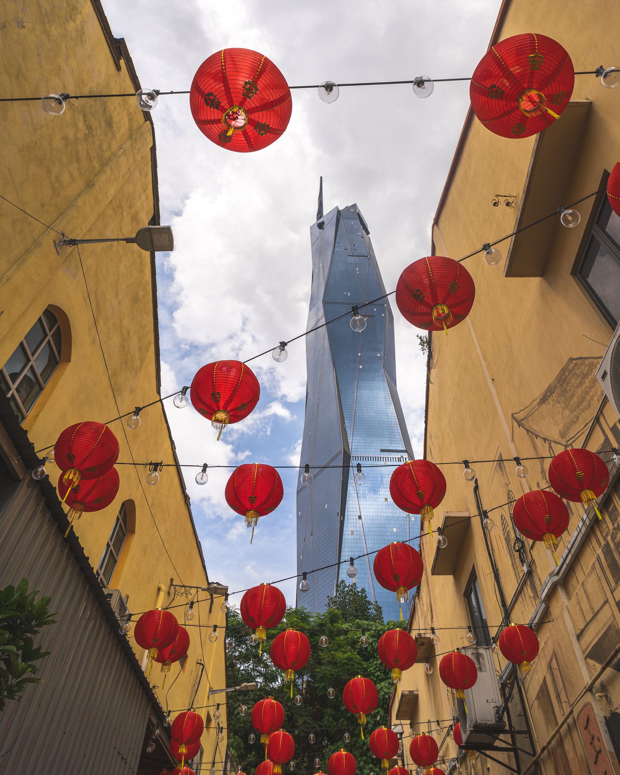 Looking up at Merdeka 118 with Chinese red lanterns in the foreground