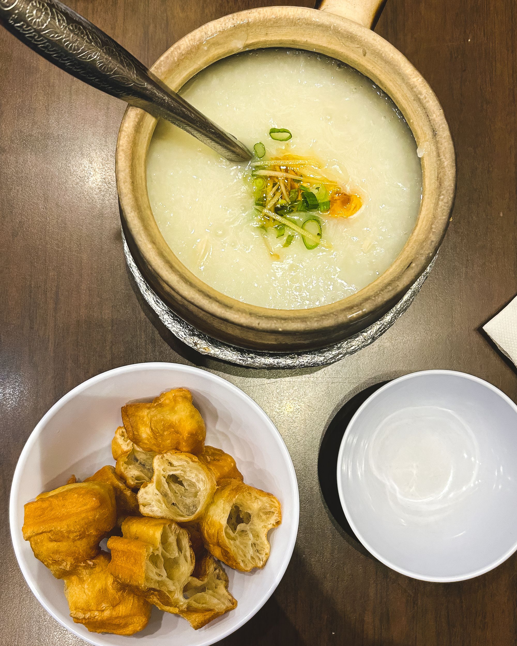 Top down shot of Shredded chicken congee and youtiao