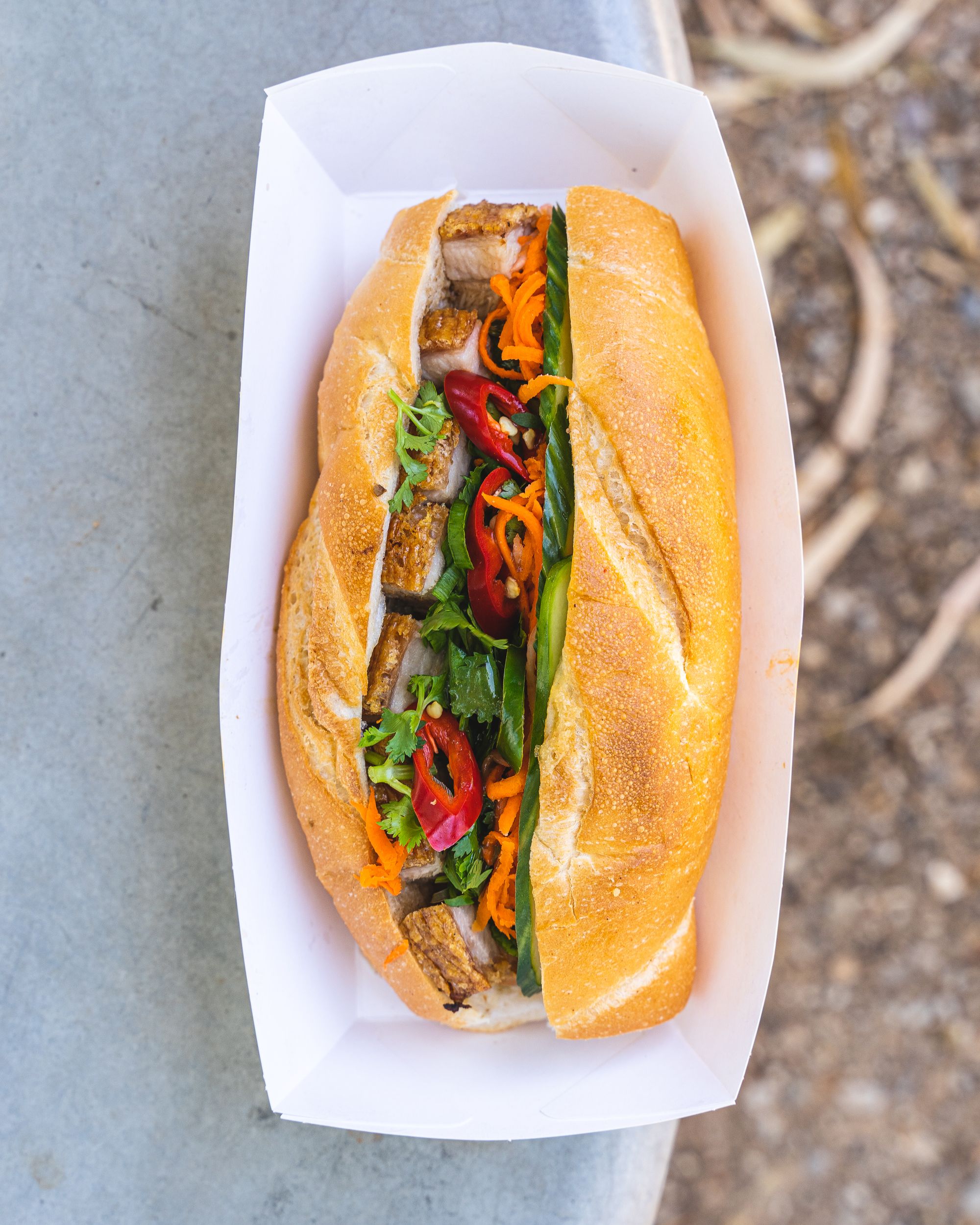 Top down shot of roast pork banh mi with chilli