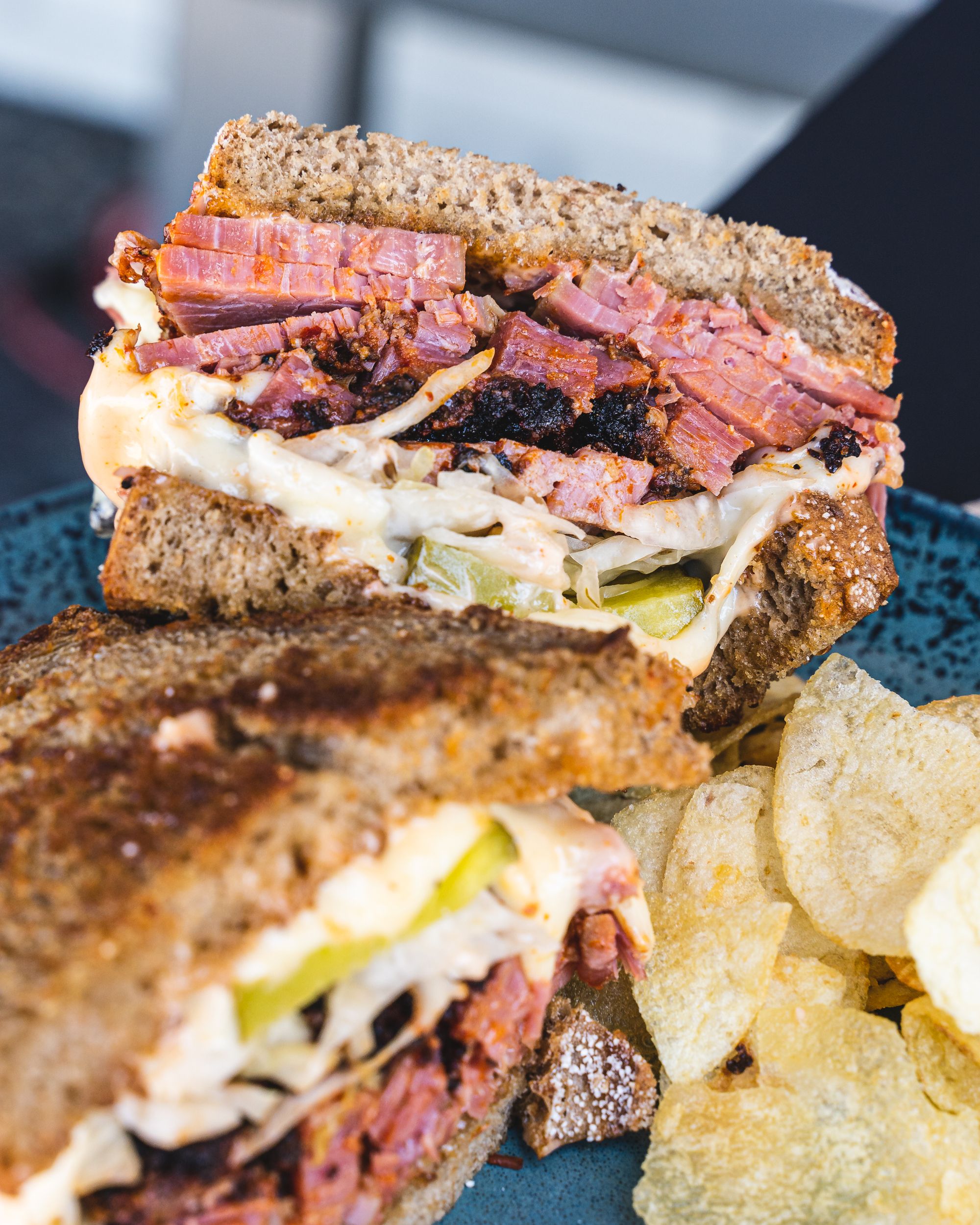 Close up of reuben sandwich with smoked pastrami and crisps