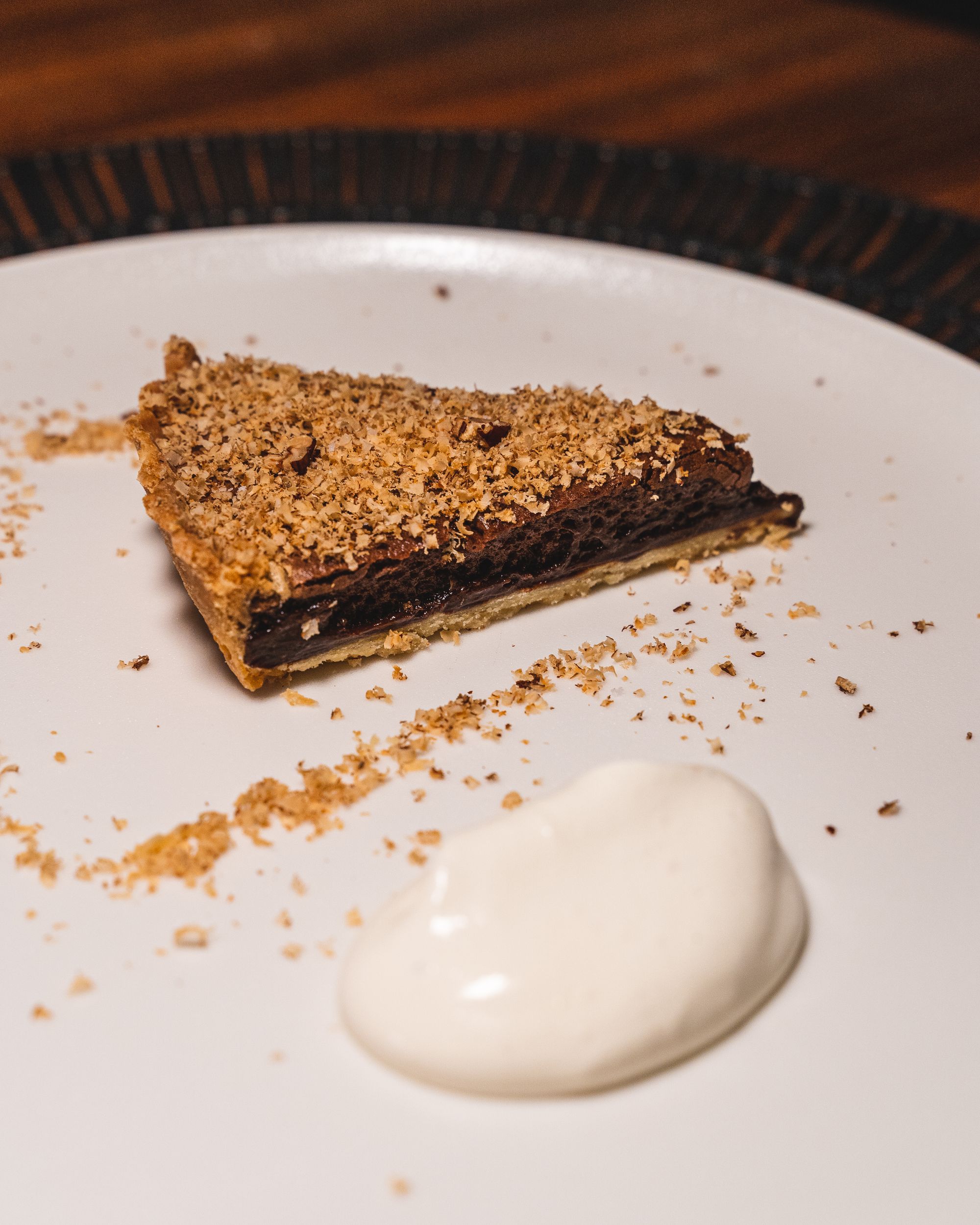 Dark chocolate tart with tonka cream on the side