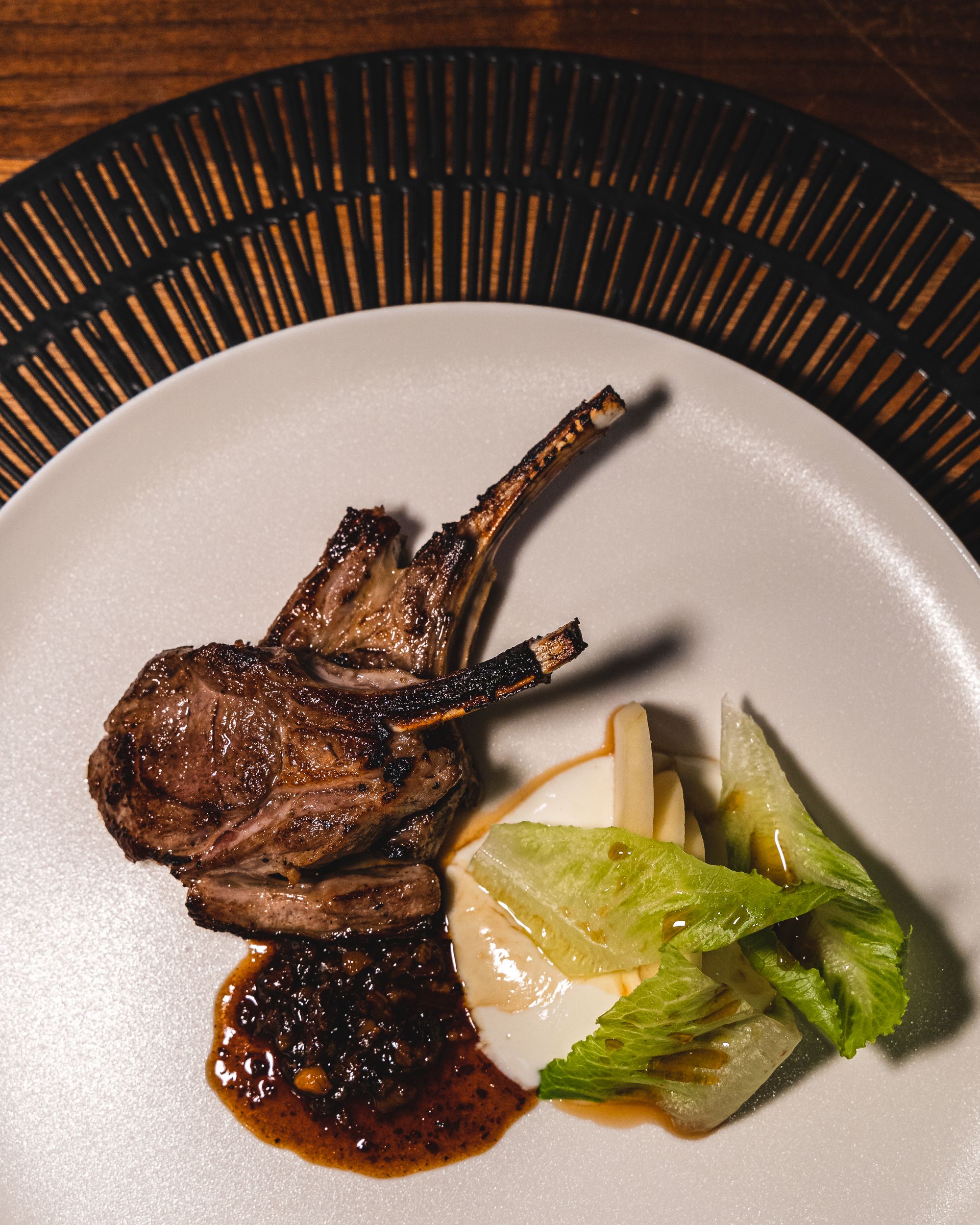 Top down shot of lamb with lettuce and mint sauce