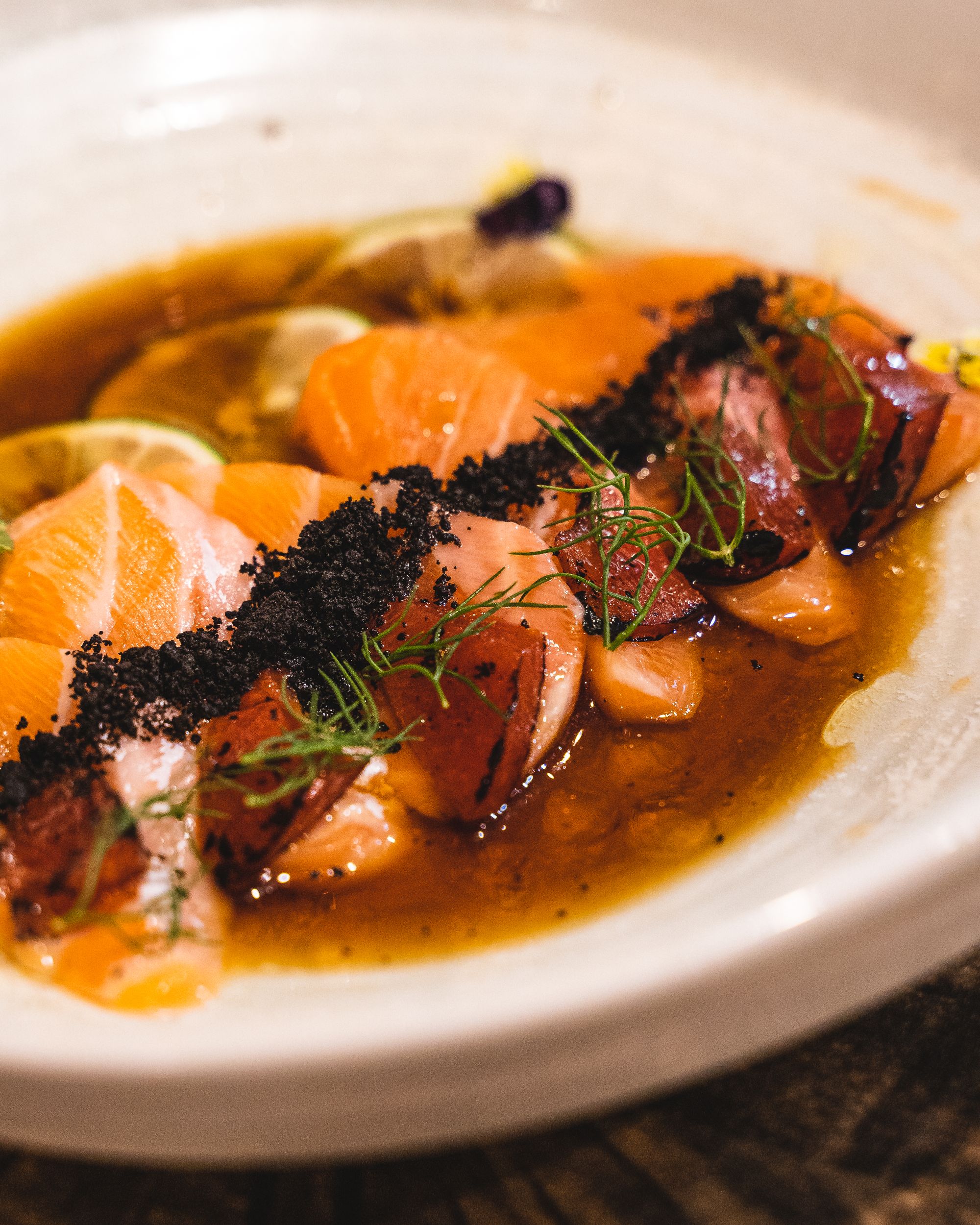 Salmon sashimi with plum and dry olive