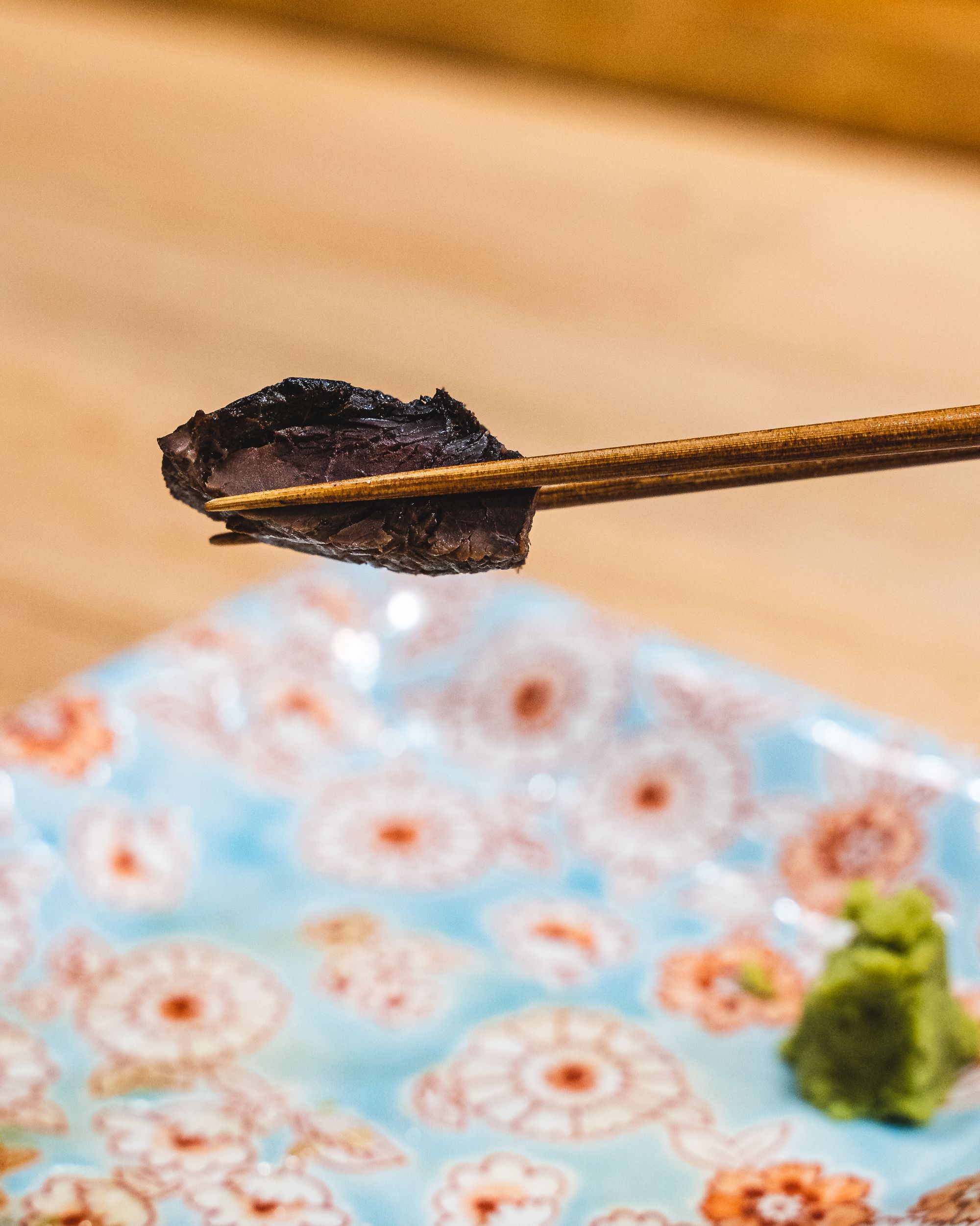 Chopsticks holding tuna bloodline
