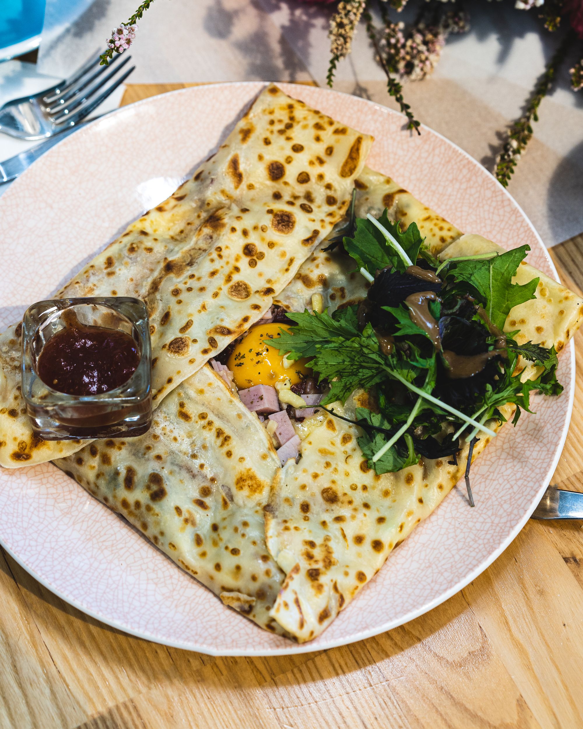 Top down shot of breakfast crepe with egg and ham