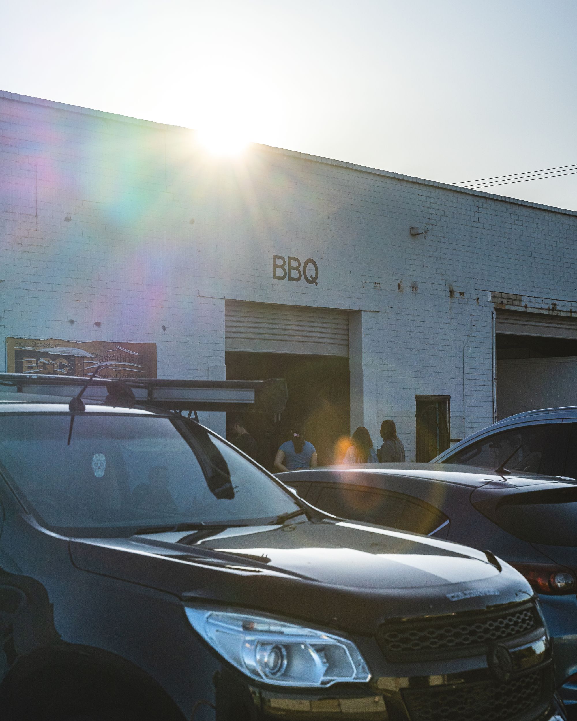 Warehouse with a "BBQ" sign spray painted by the roller door