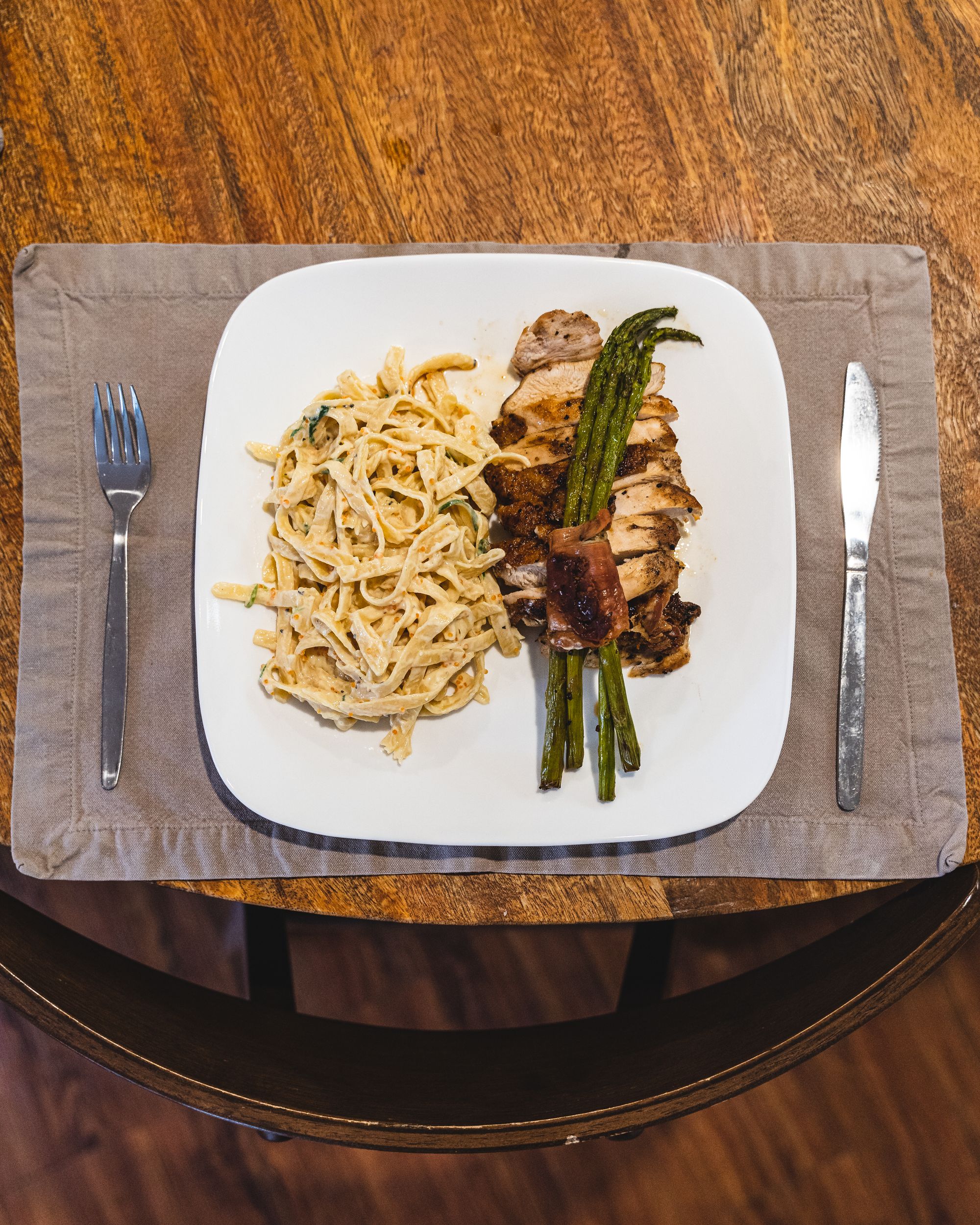 Top down shot of creamy pasta and asparagus wrapped in bacon