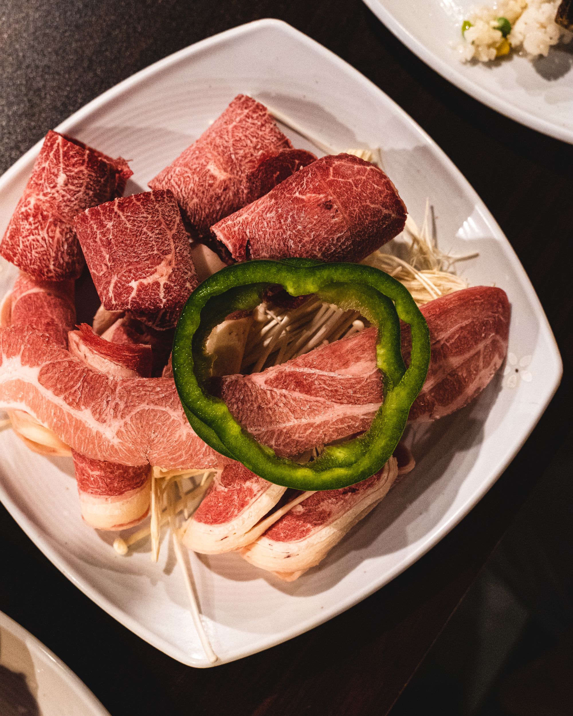 Assorted raw red and white meats on a plate