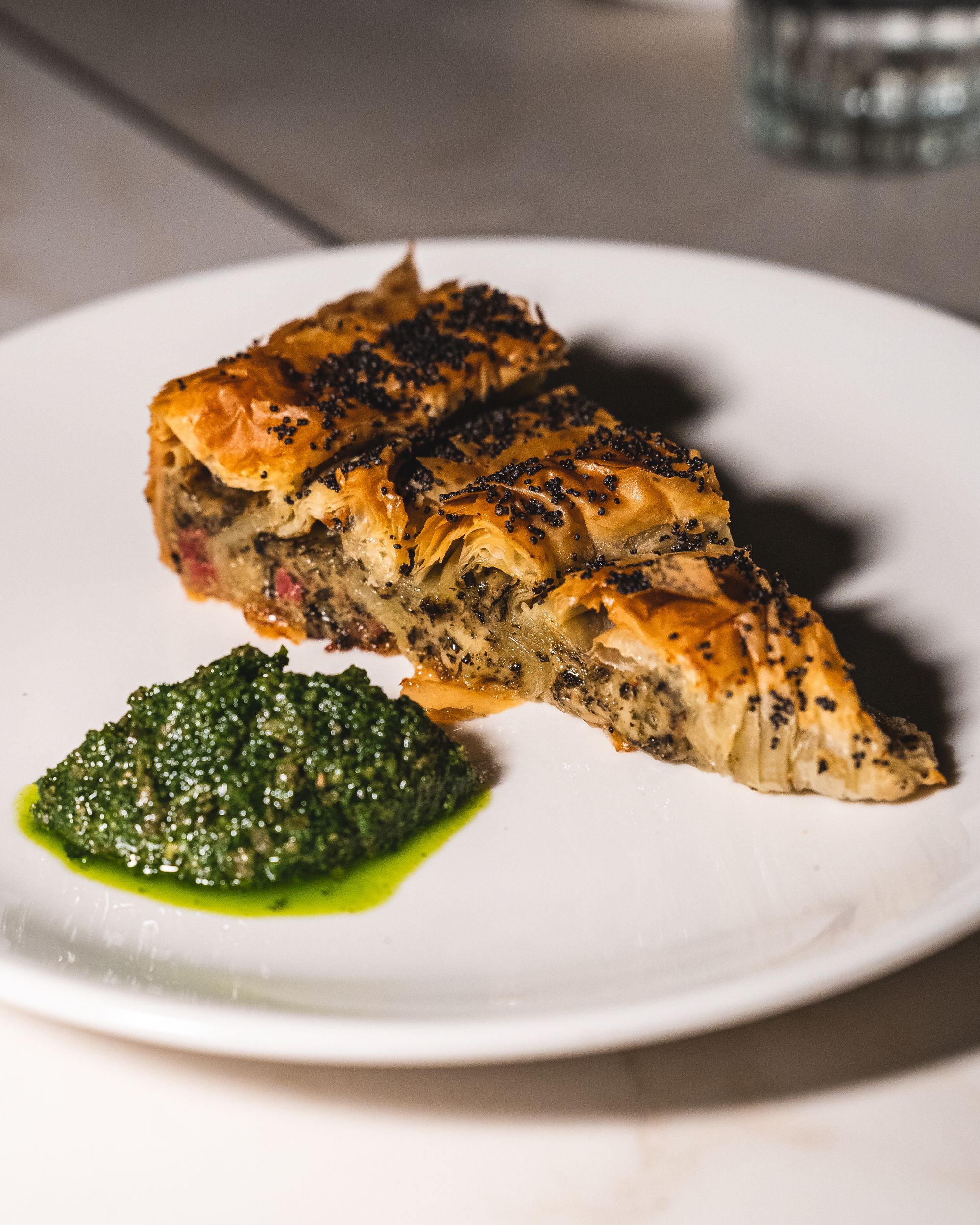 Close up of pie with mint sauce on the side