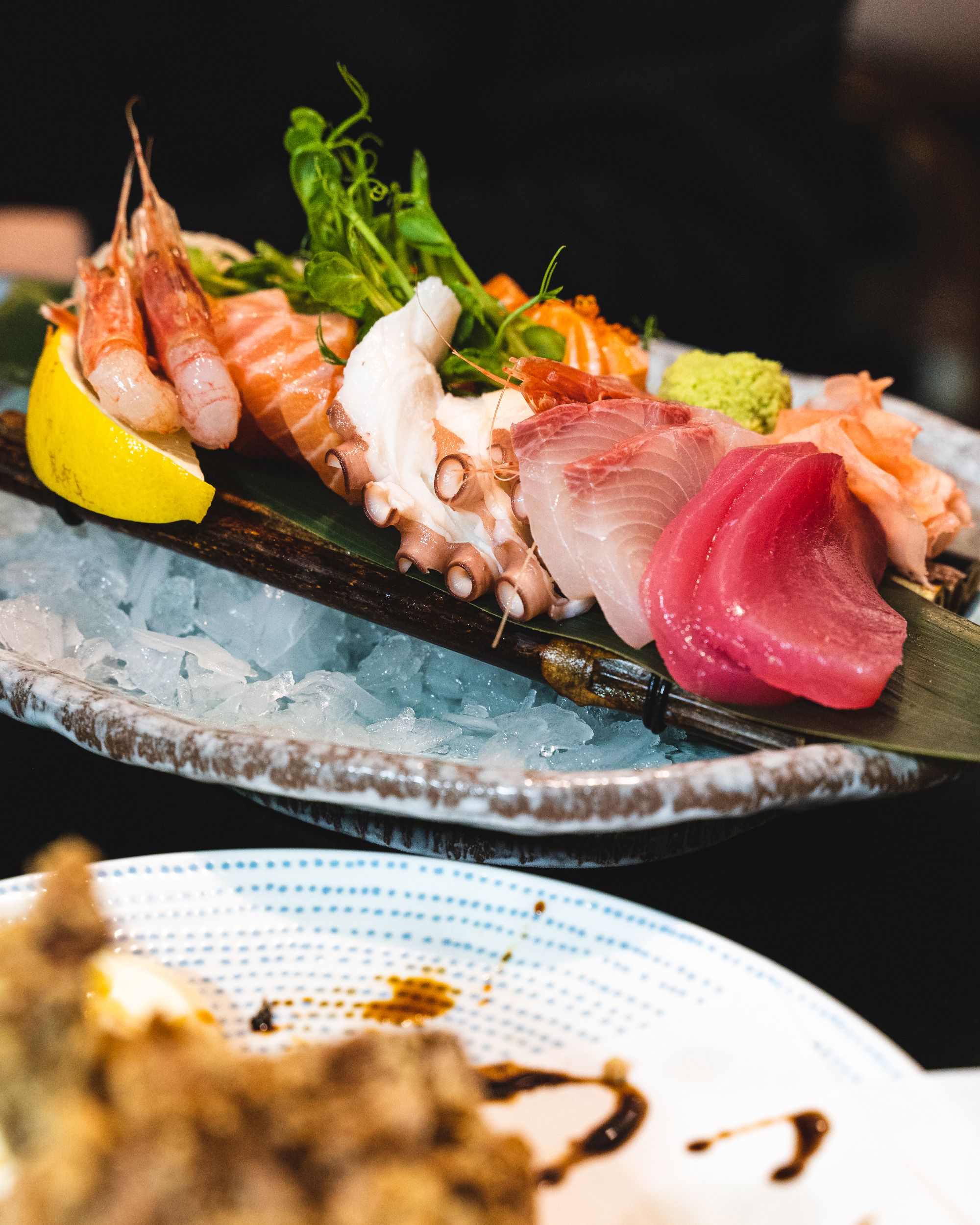 Close up of an assorted sashimi platter with scampi, salmon belly, octopus, yellowtail and tuna