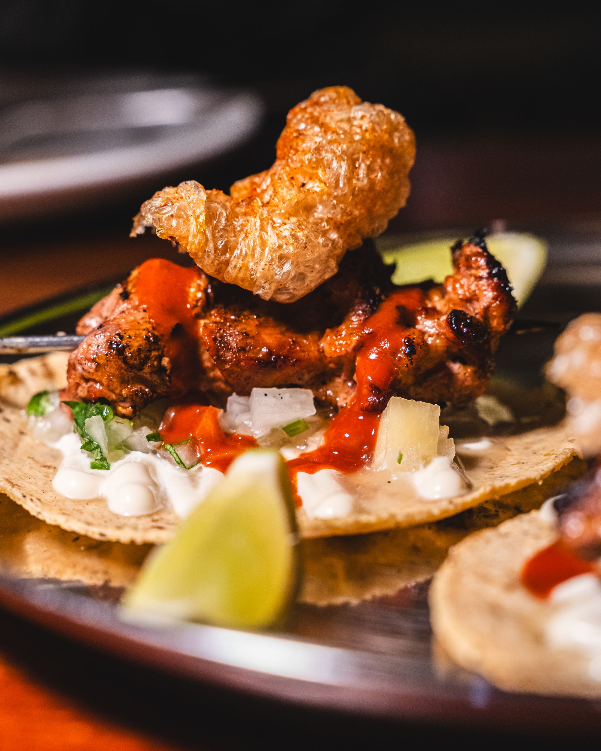 Pork tacos with chicharron on top 