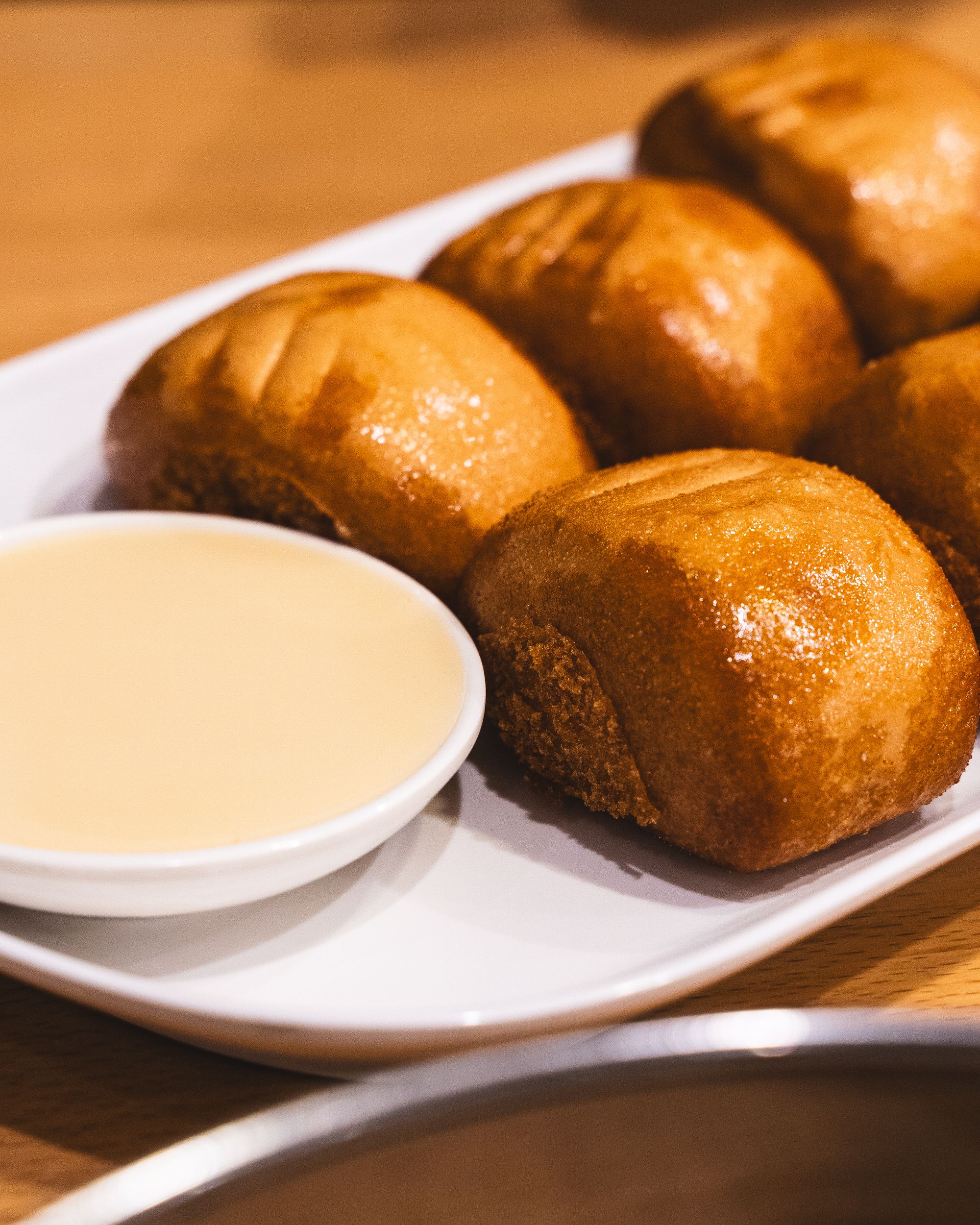 Fried mantou with condensed milk in a ramekin