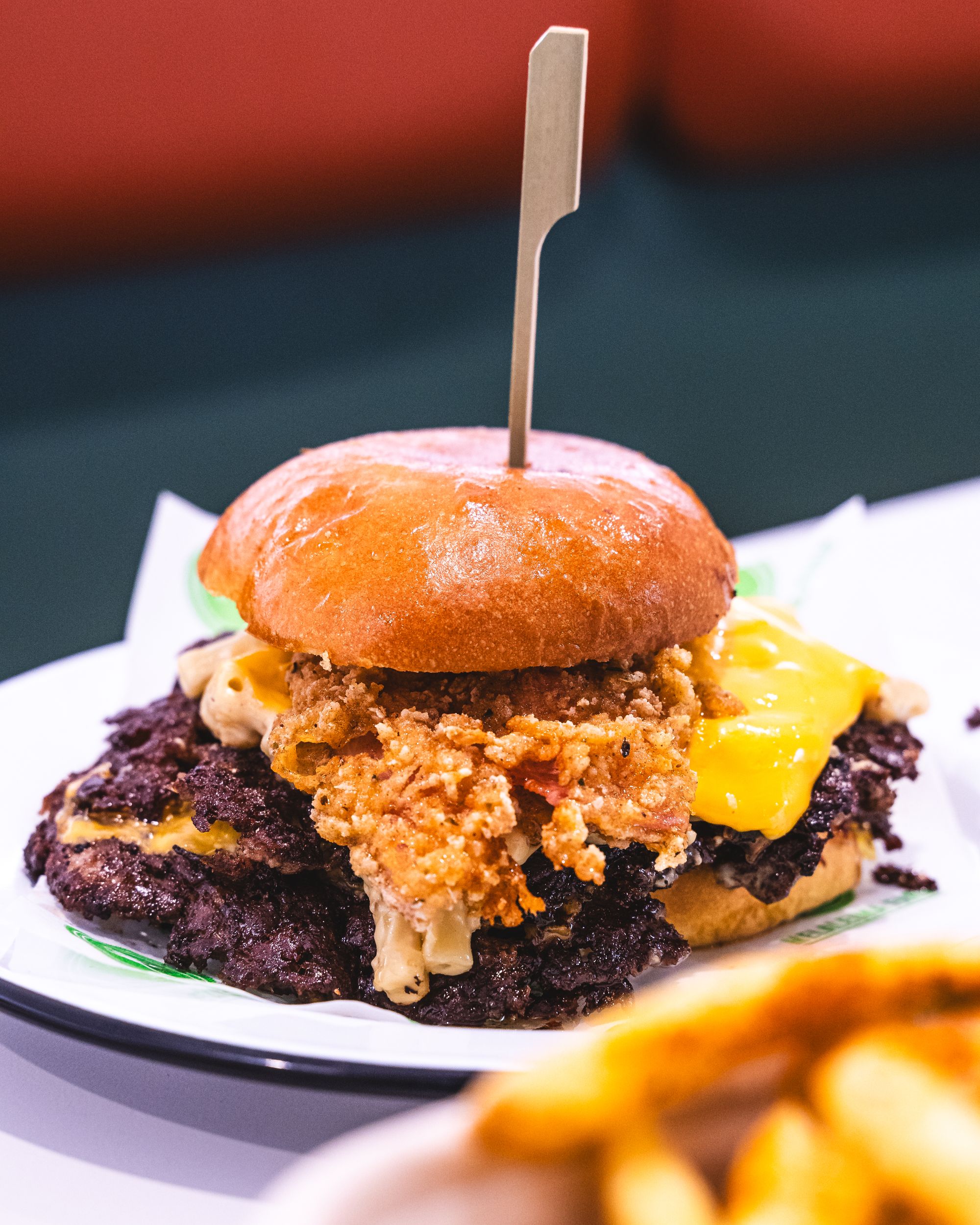 Close up of smashed beef burger with crispy bacon and cheese