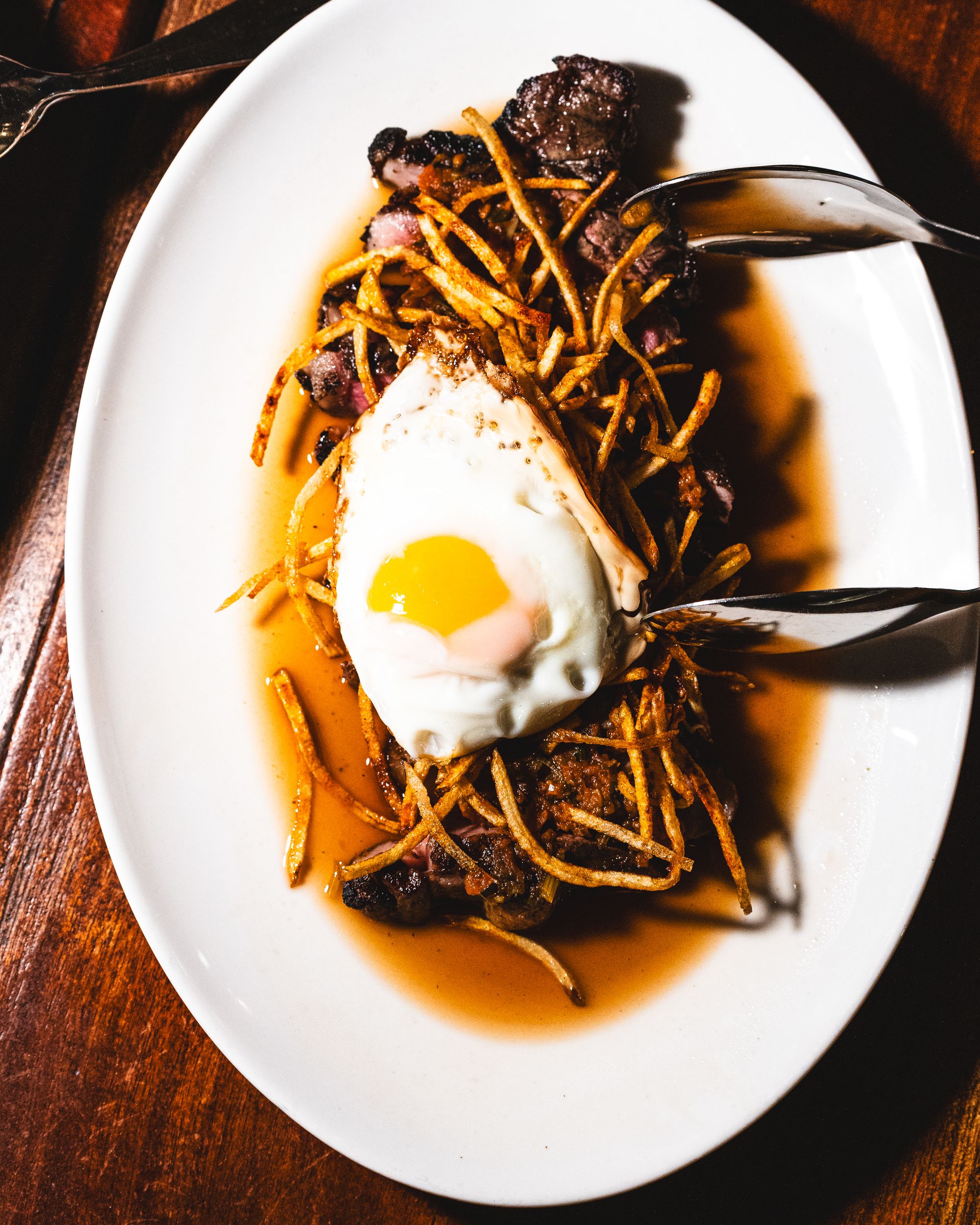 Top down shot of fried steak with fried egg on top