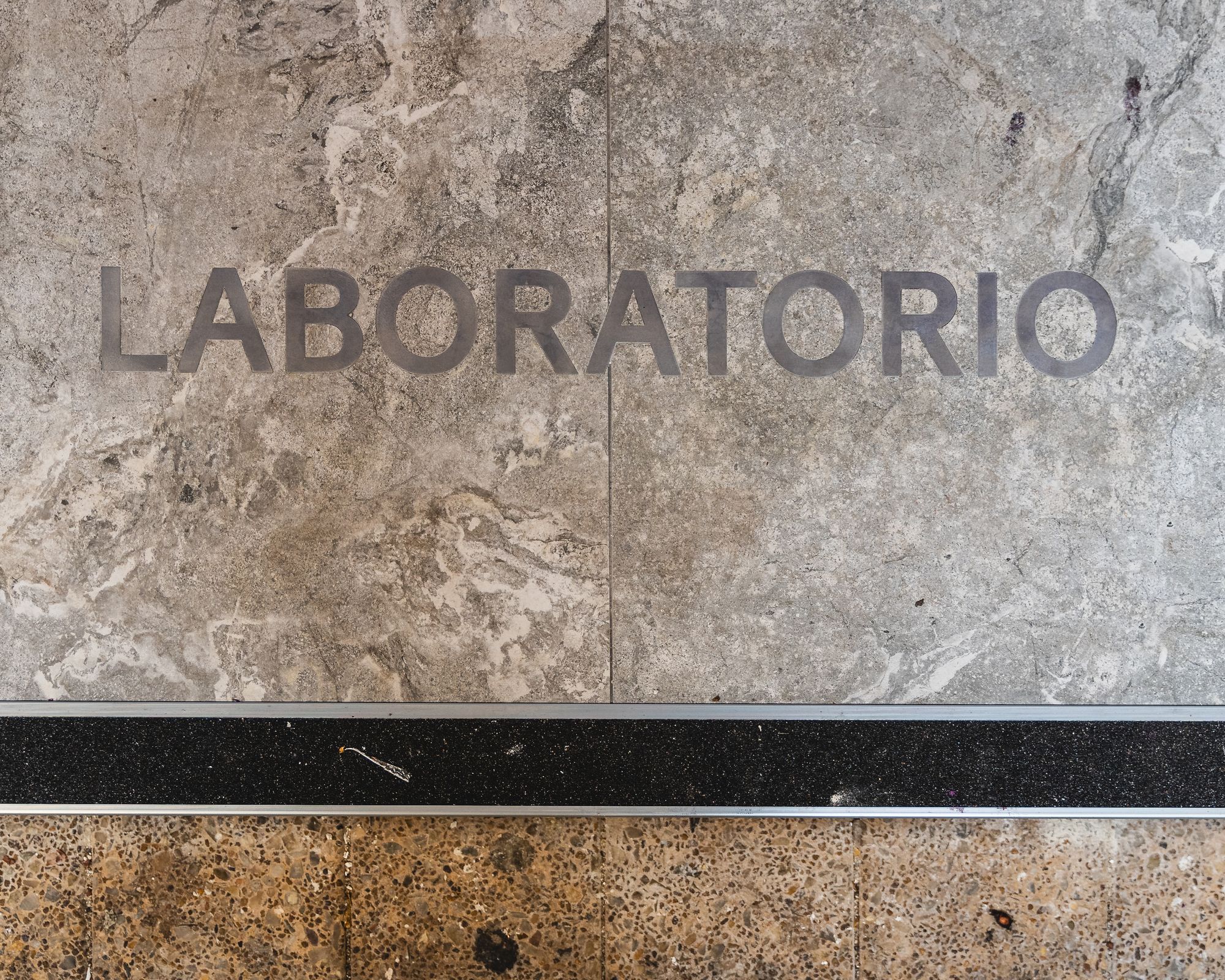 Tiled floor with the word laboratorio printied in it