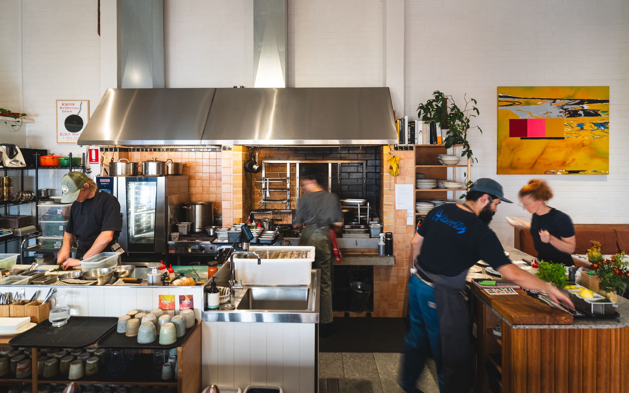 Busy open kitchen restaurant with chefs at work