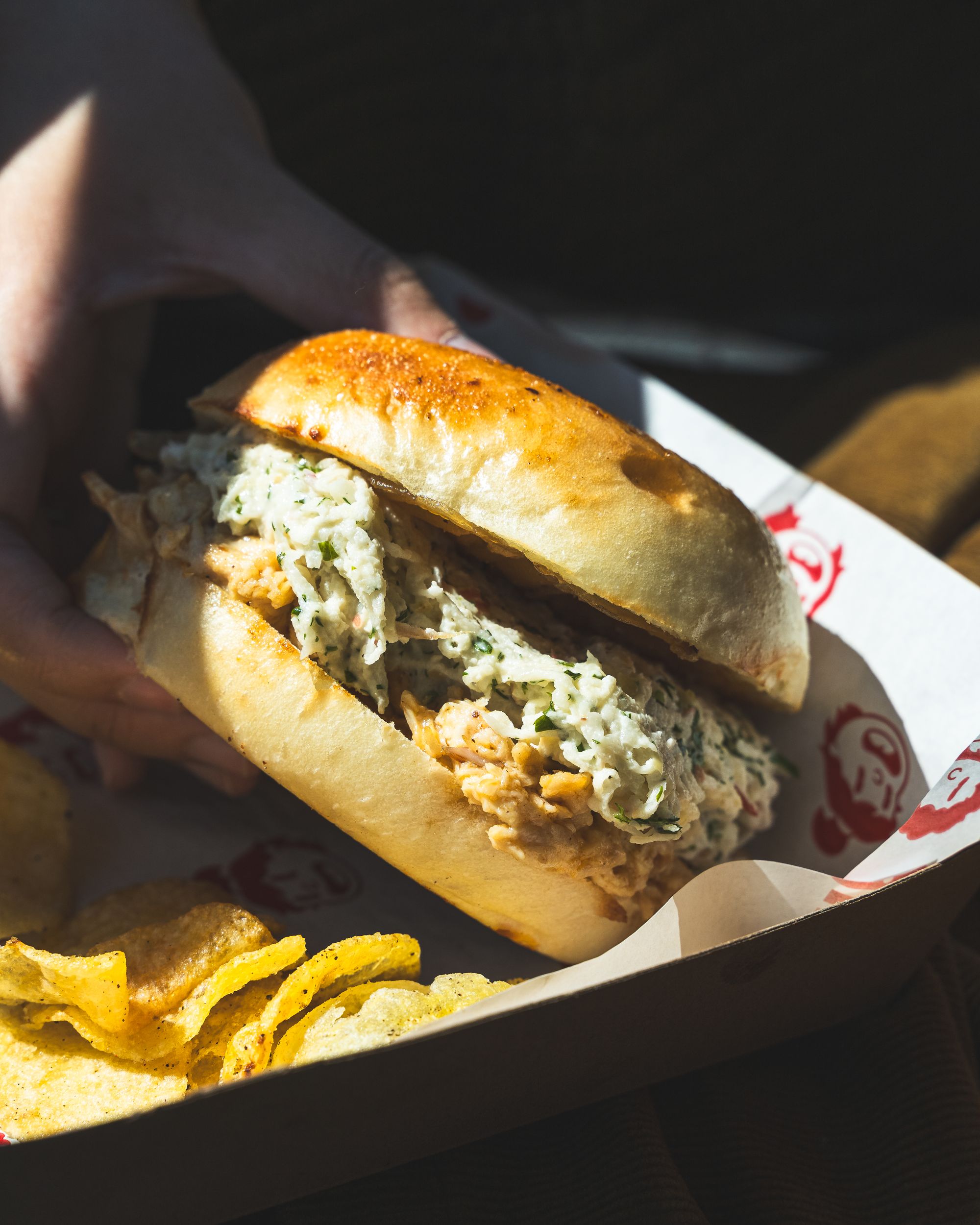 Close up of chicken roll with crisps