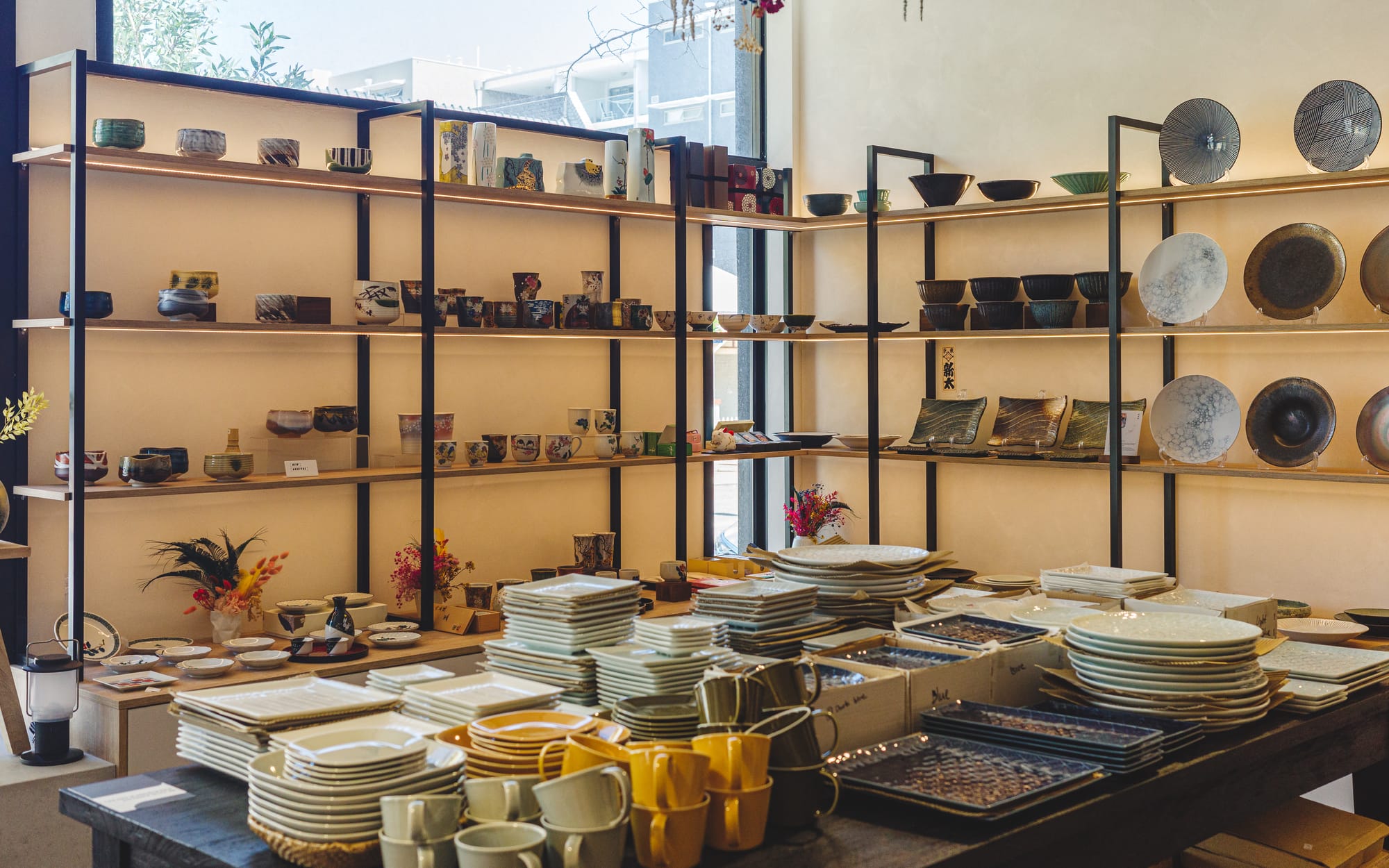 Interior of Japanese homewares store showing lots of different plates, bowls and mugs