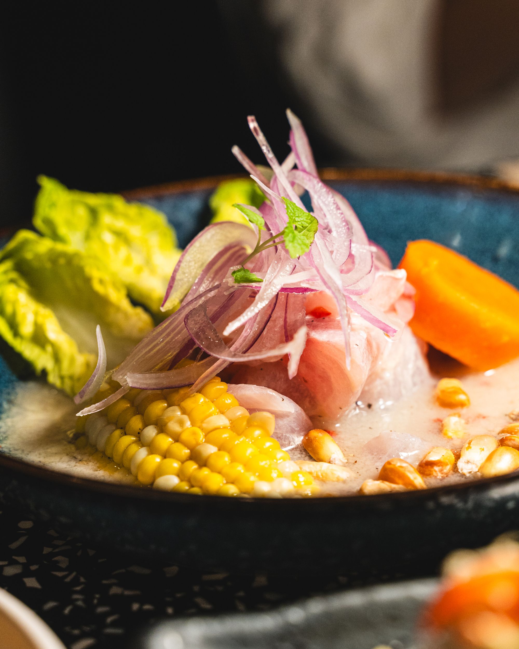 Close up of ceviche with corn, onion and sweet potato