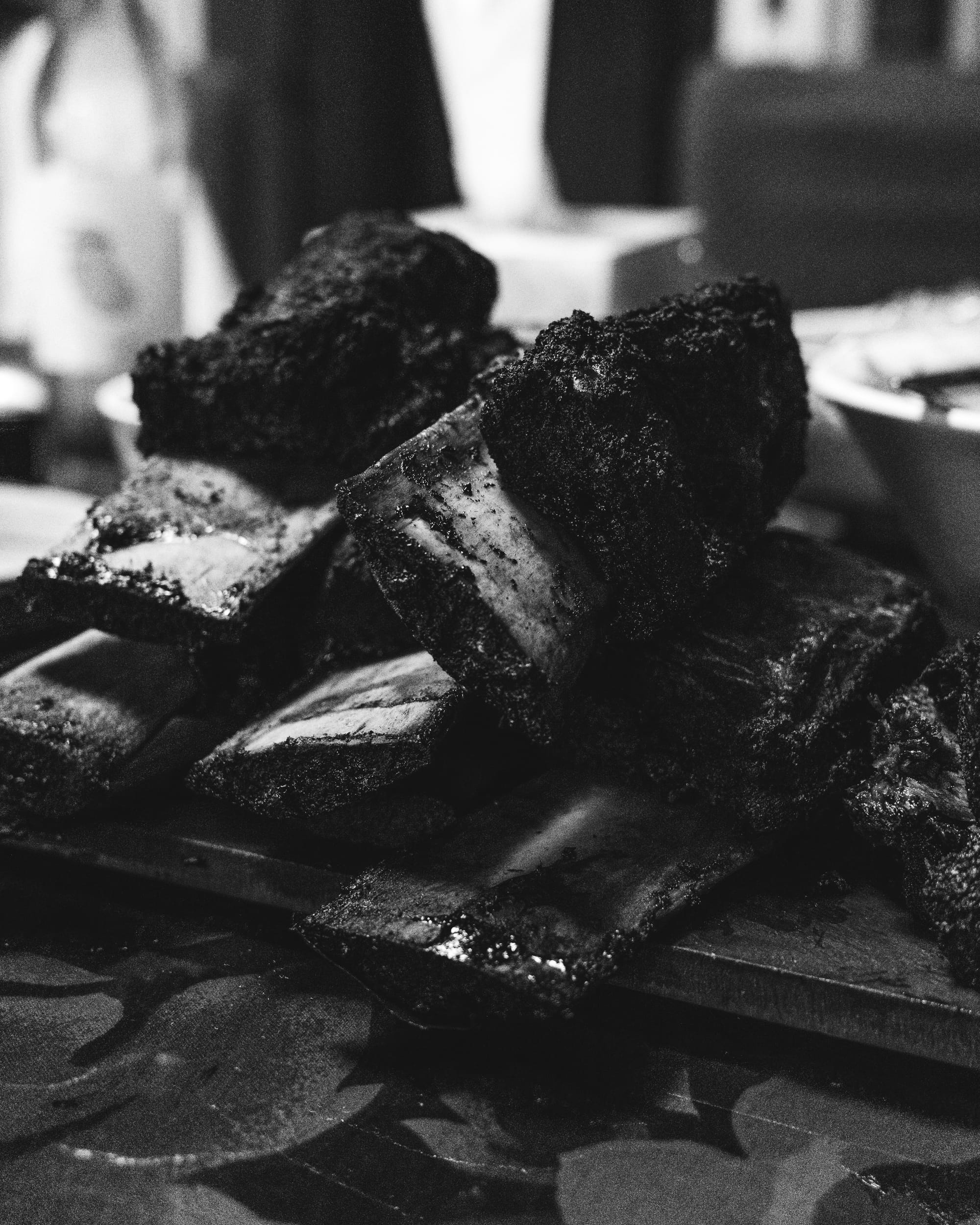 Black and white photo of close up of smoked beef ribs piled up