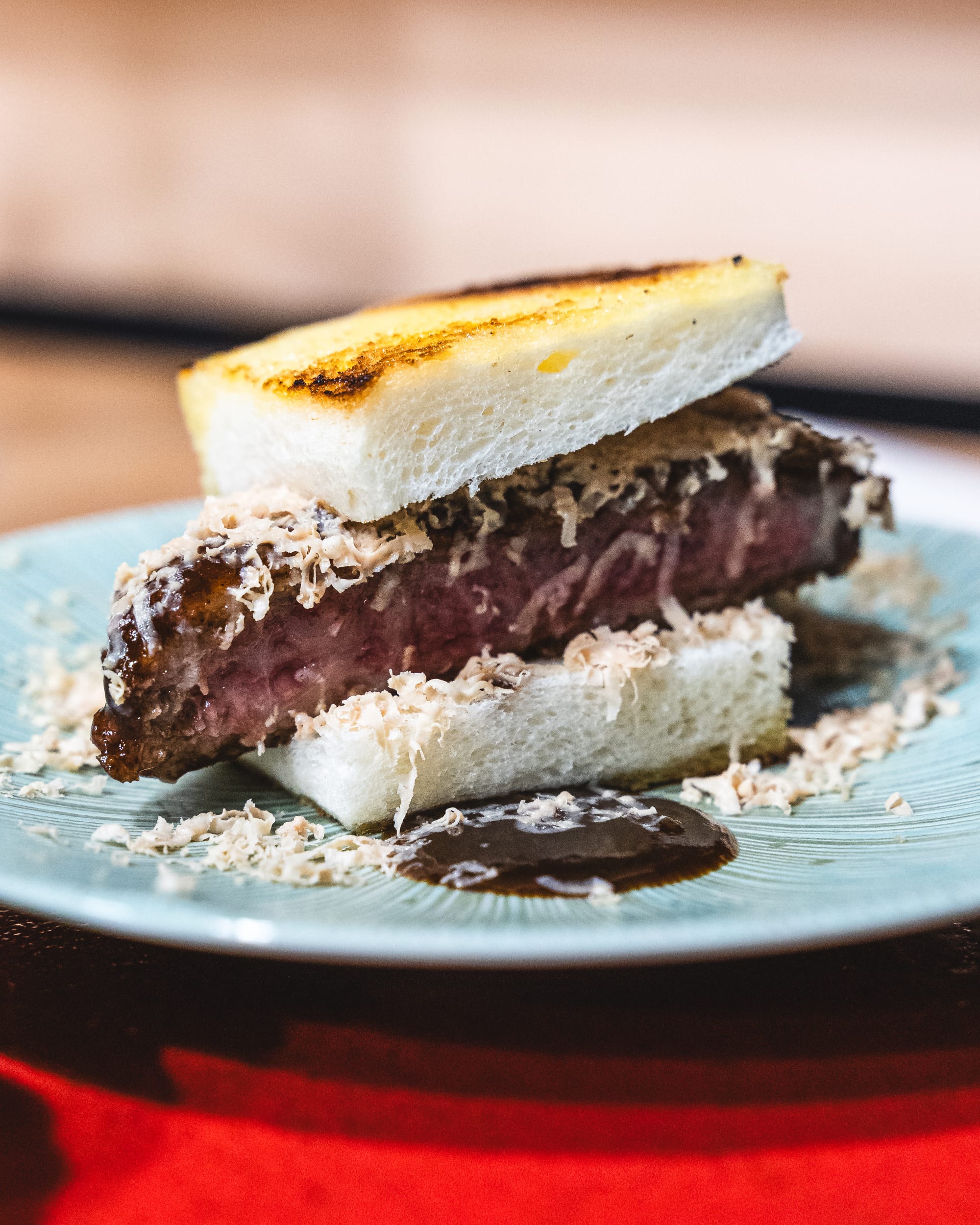 Close up of wagyu katsu sando with shaved foie gras