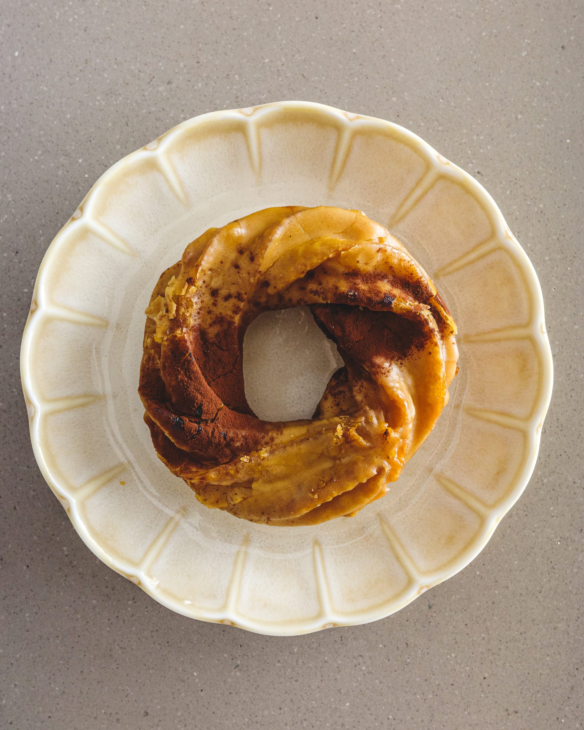 Top down photo of cruller donut on a flower shaped plant