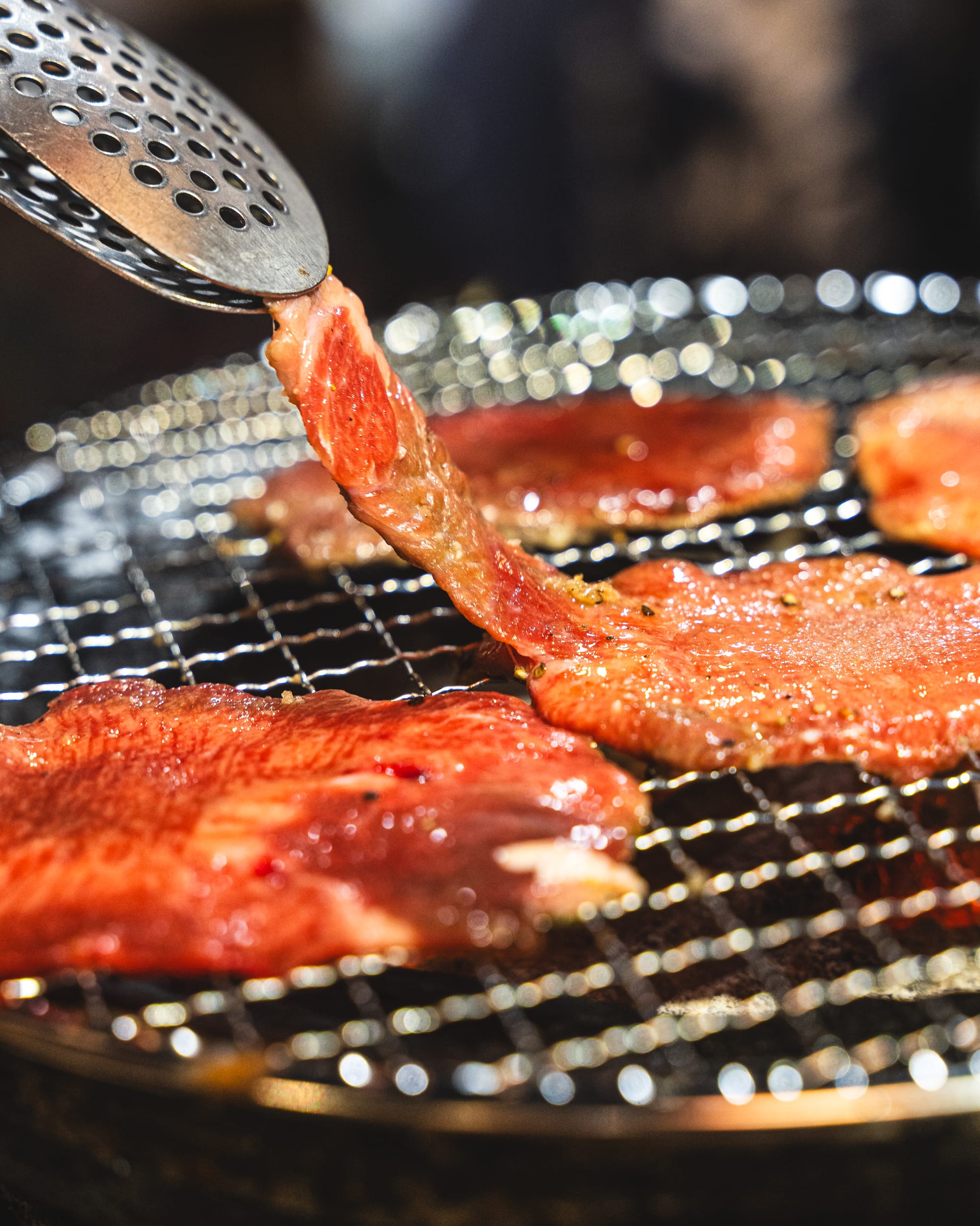 Close up of a thin slice of wagyu being grilled