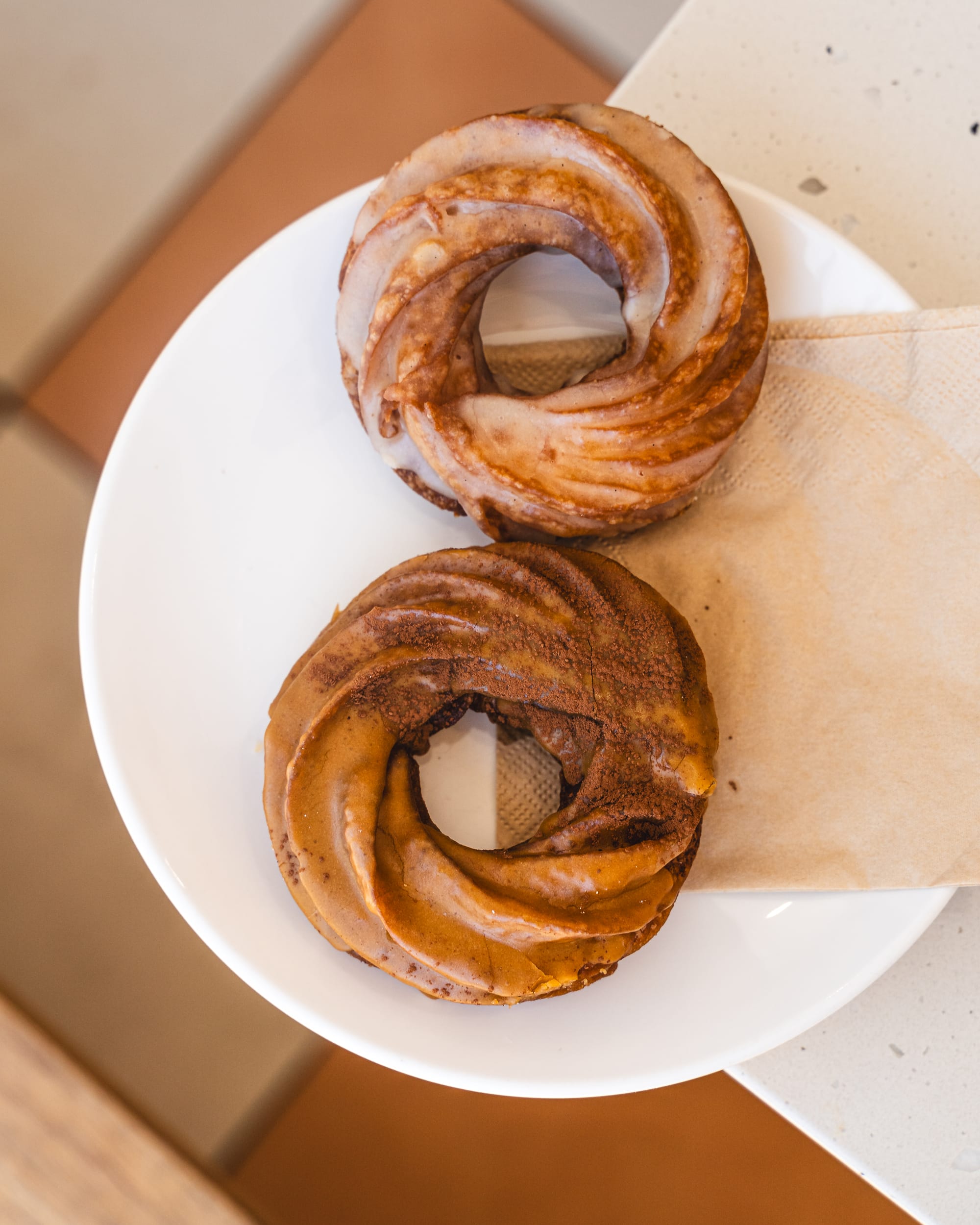 Top down shot of two cruller donuts on a plate