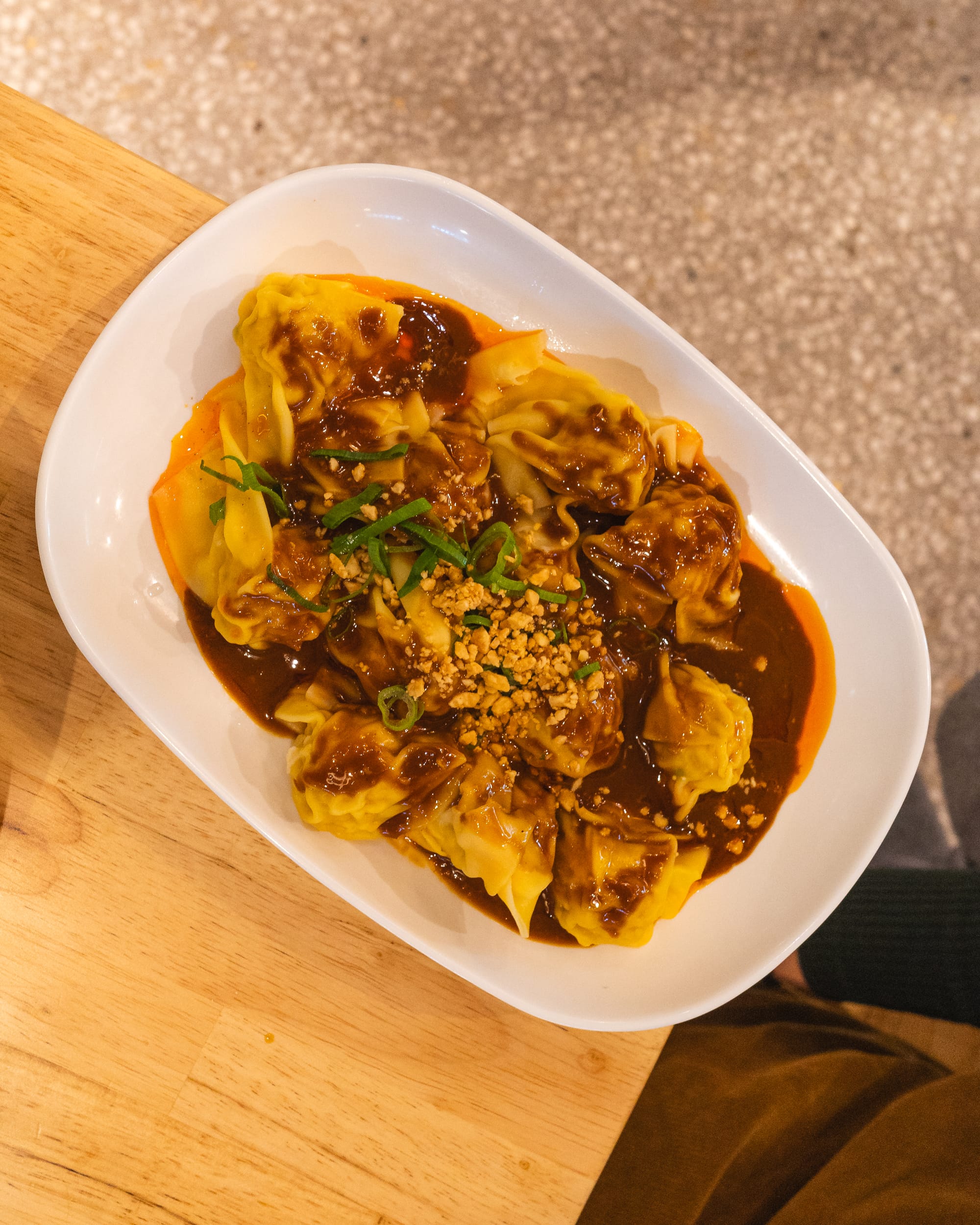 Top down shot of wantons with spicy peanut sauce