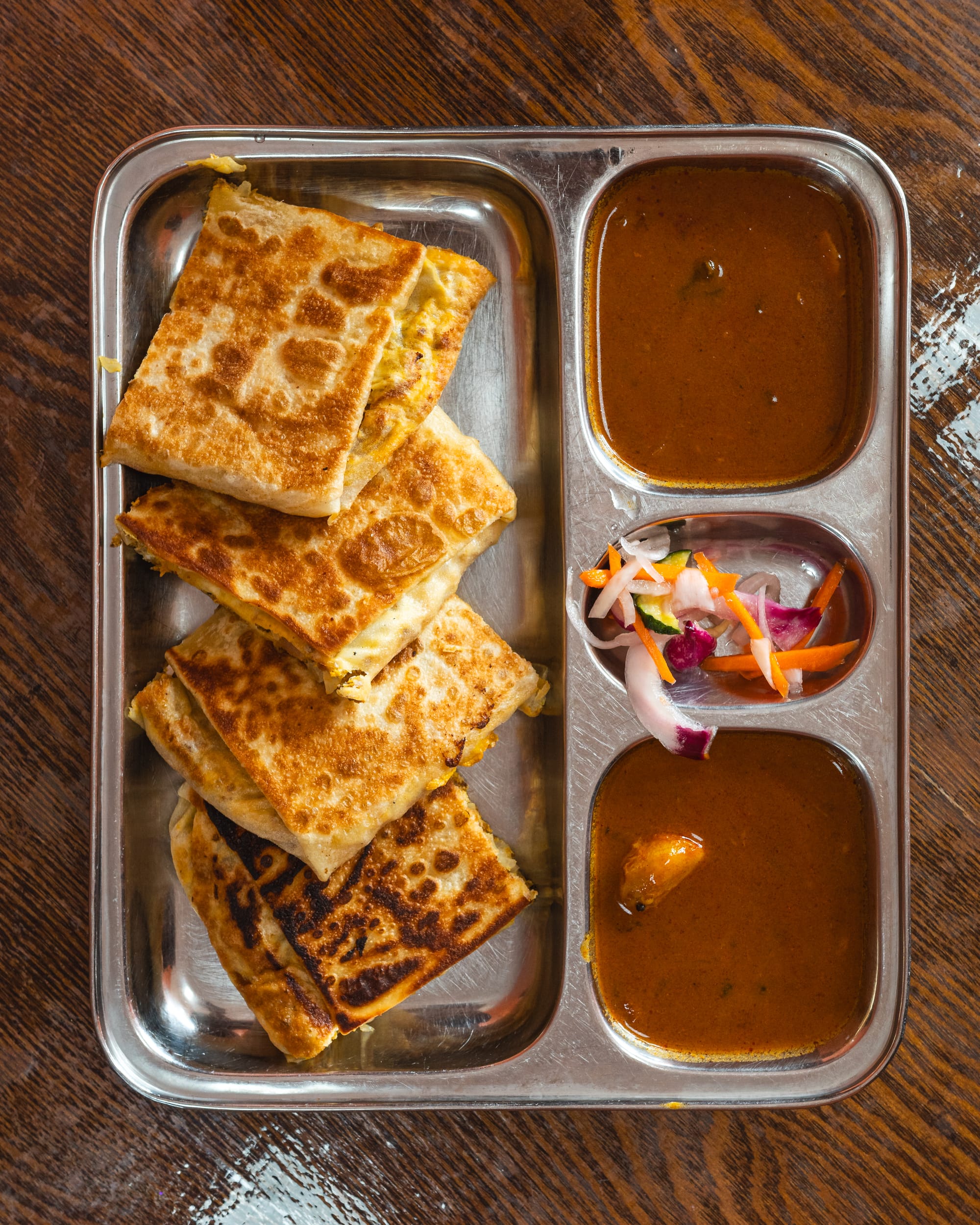 Top down shot of murtabak with curry on side