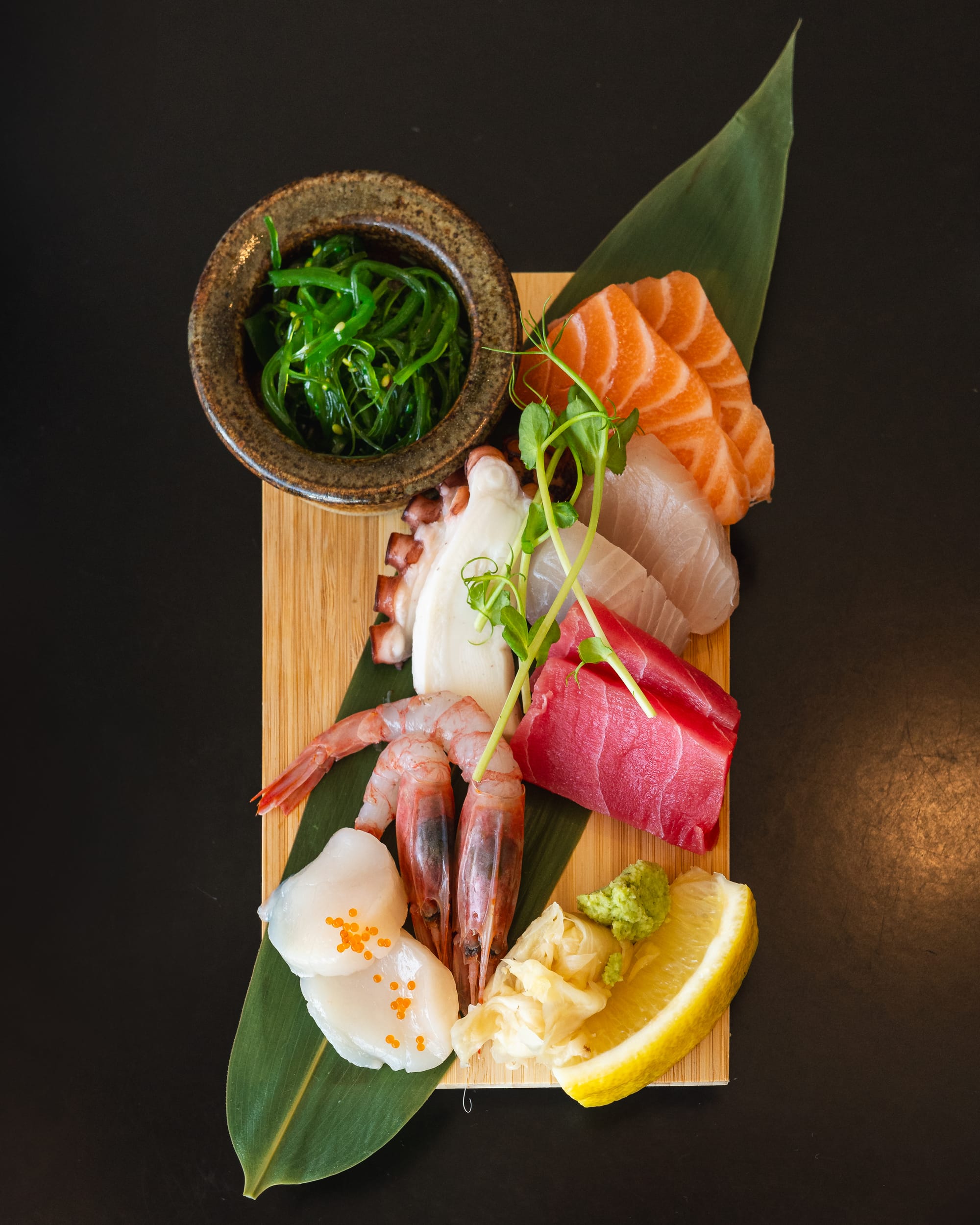 Top down shot of sashimi platter with amaebi, scallop, tuna, whitefish, salmon and octopus