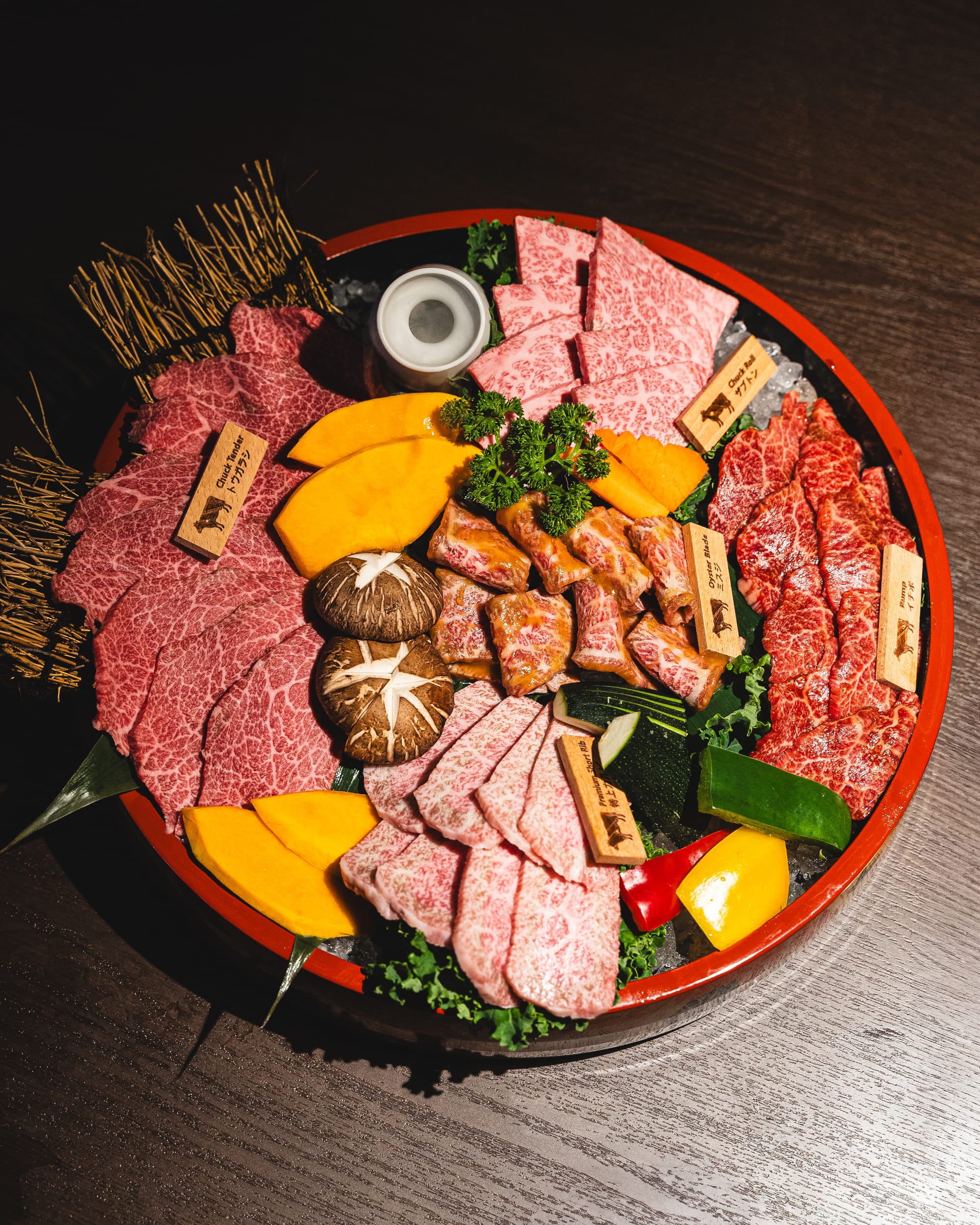 Top down shot of wagyu meat platter with sweet potato, mushroom and capsicum as garnish