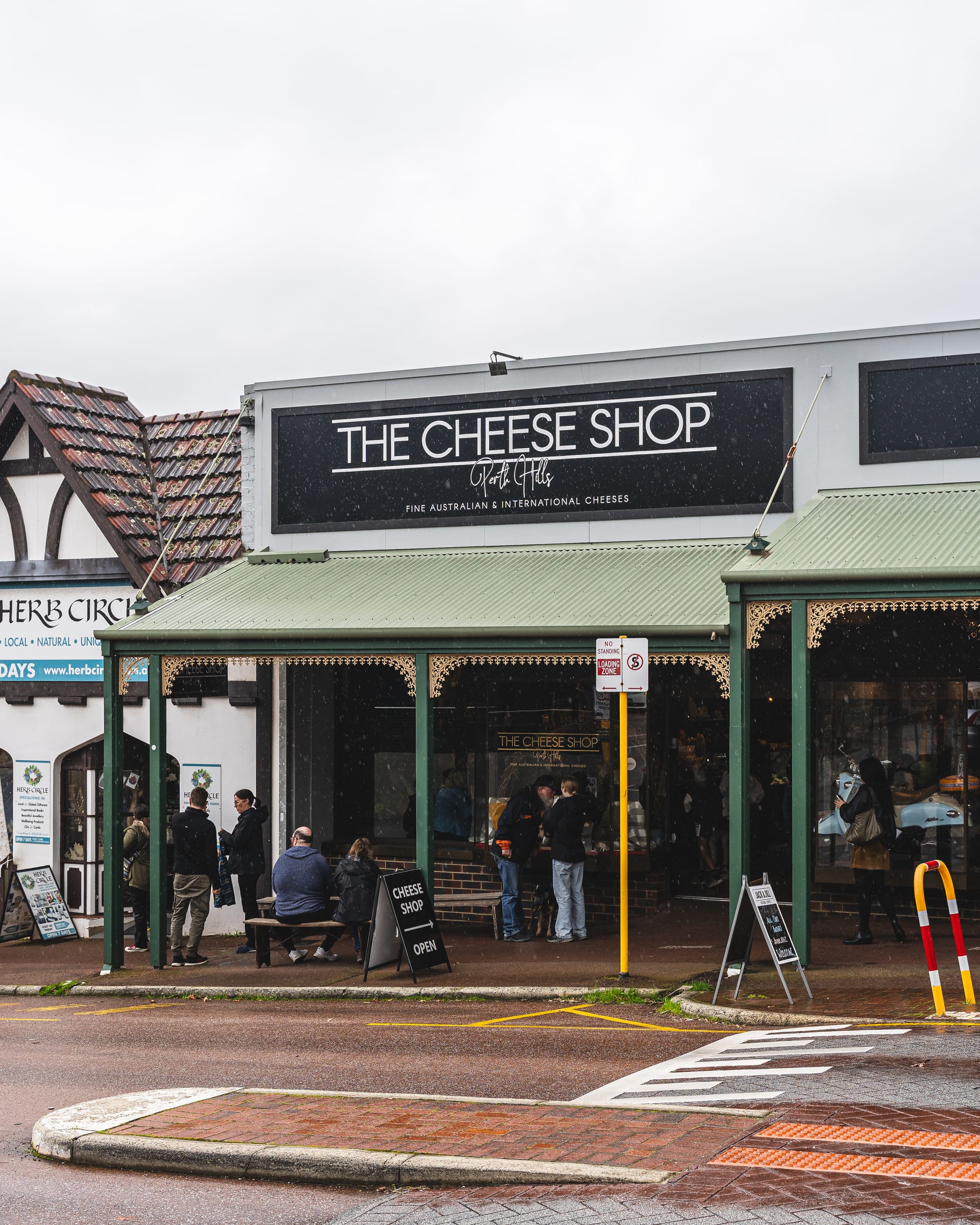 Exterior of The Cheese Shop with people dining outside