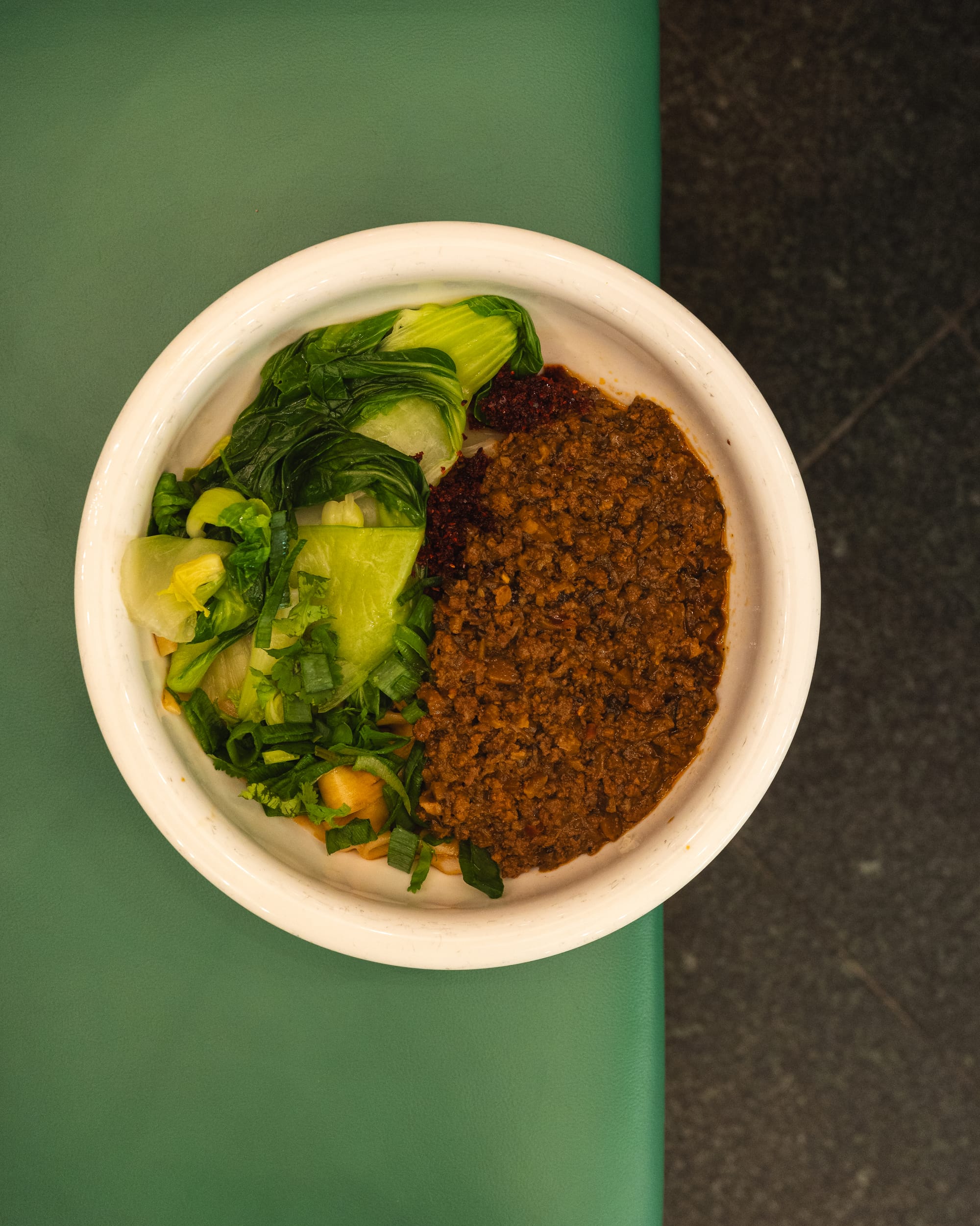 Top down shot of noodles with mince beef and bok choy