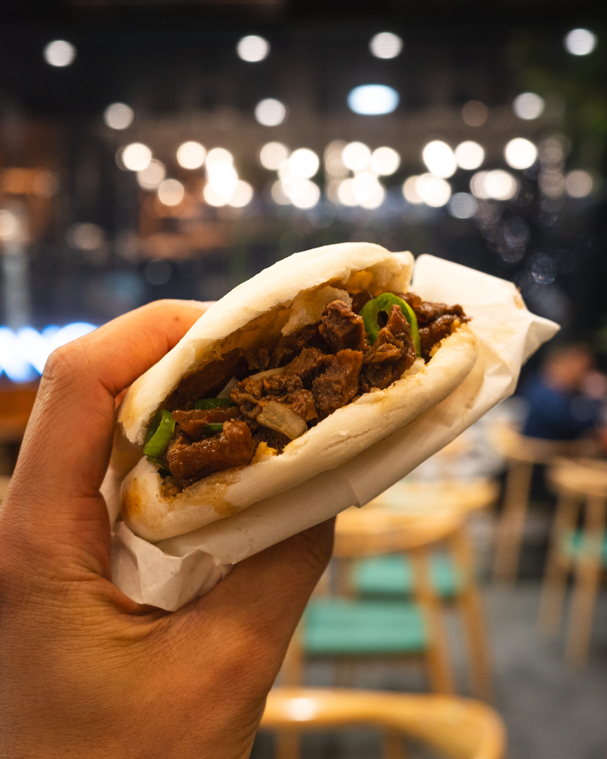 Hand holding bao with beef 