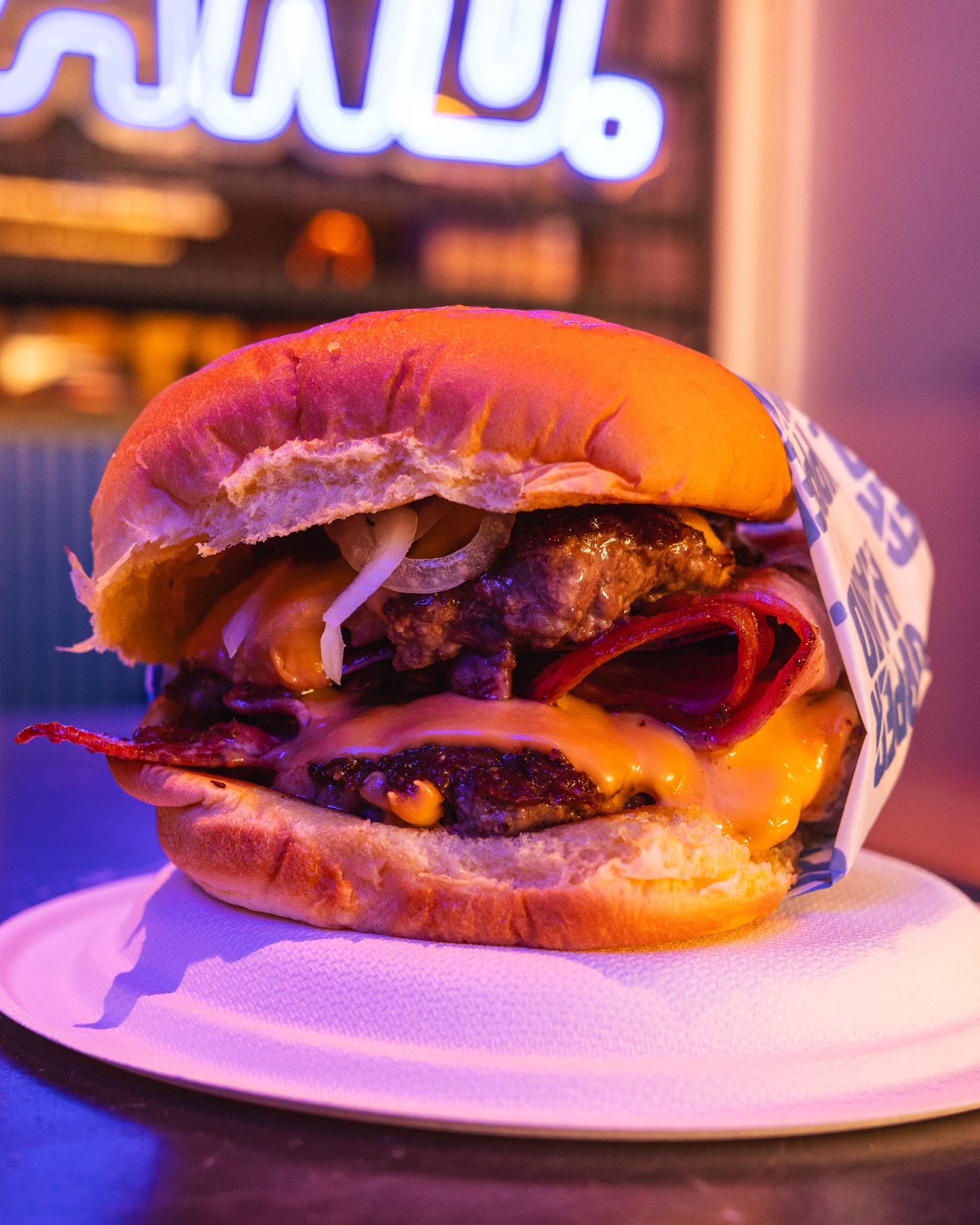 Close up of burger with meat and bacon showing