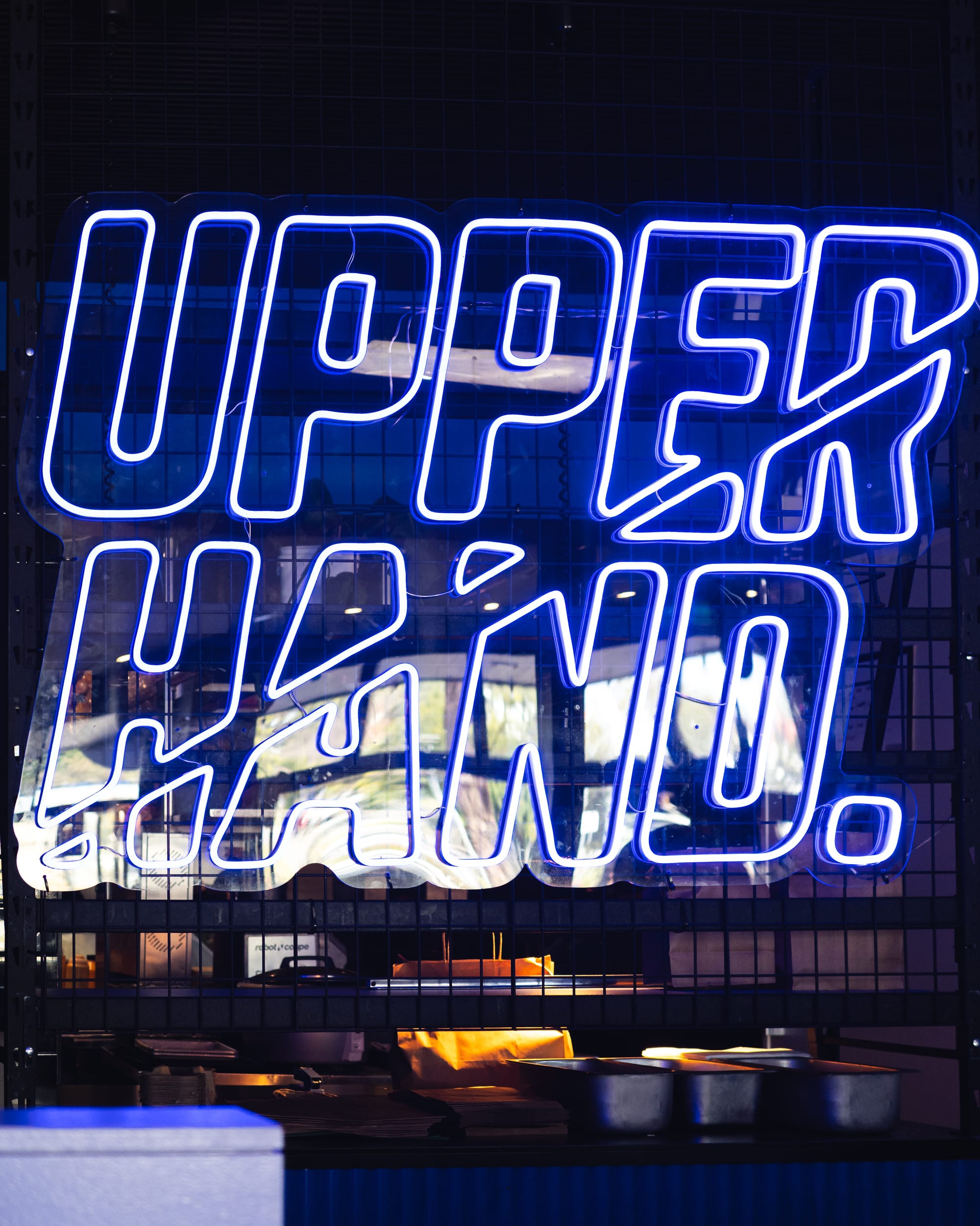 Neon sign that says "Upper Hand"