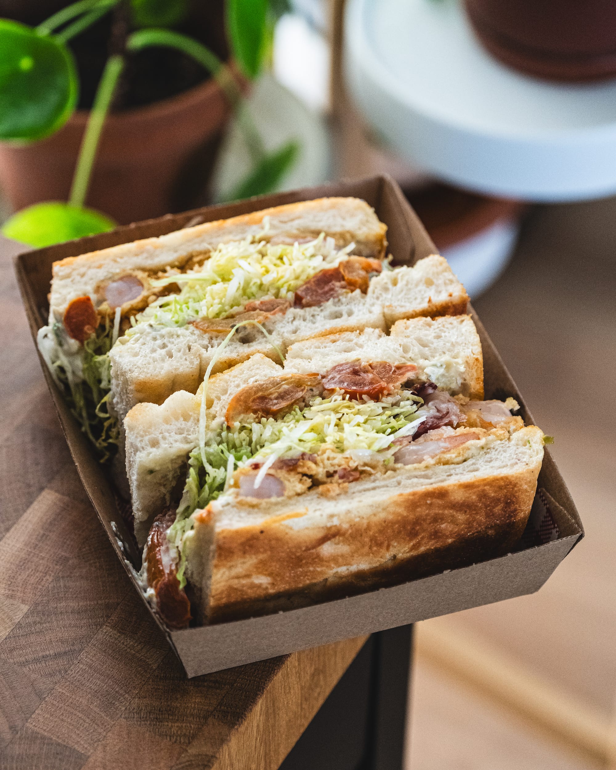 Close up of focaccia sandwich with prawn, lettuce and tomato