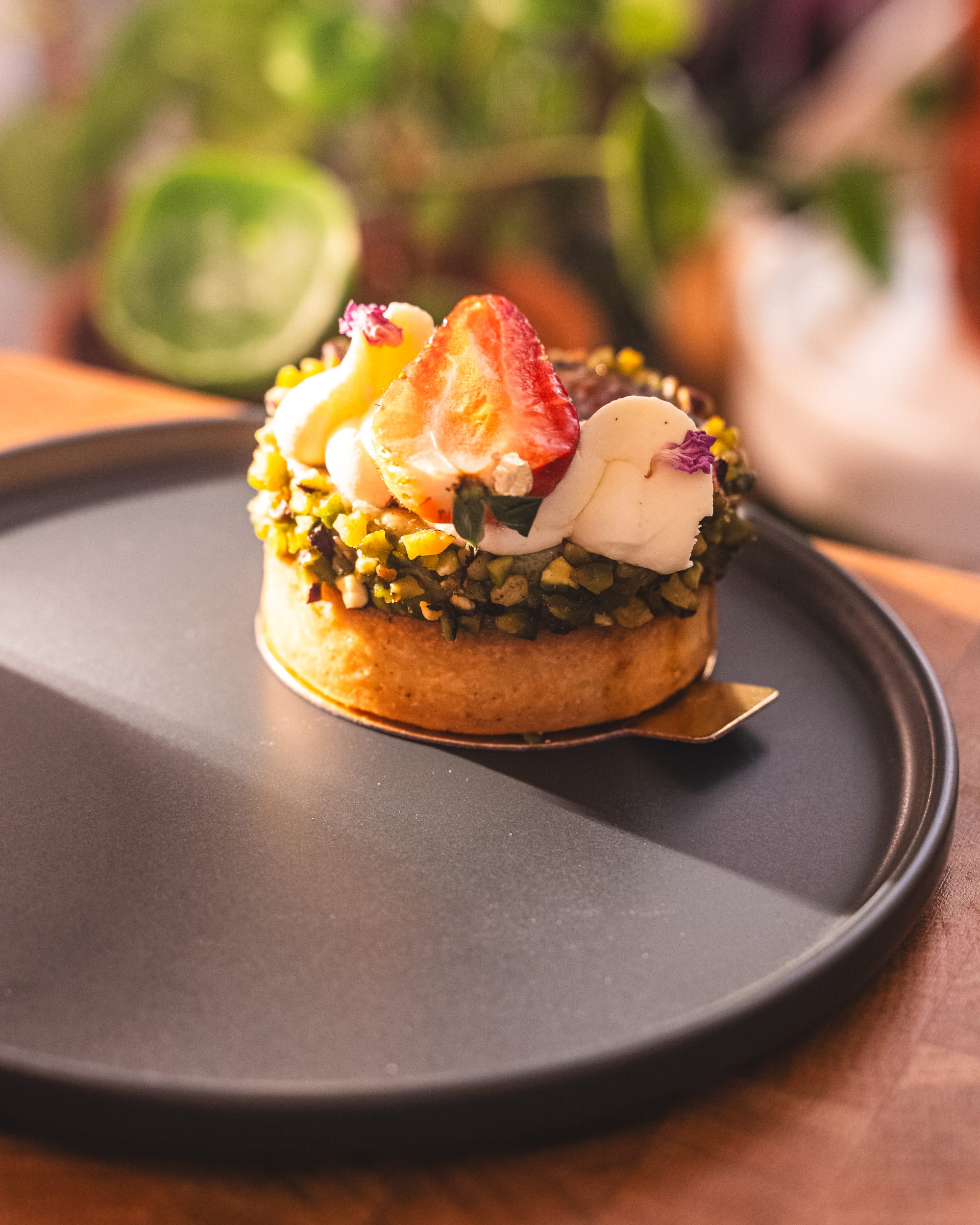 Close-up of chocolate pistachio tart with strawberry ontop