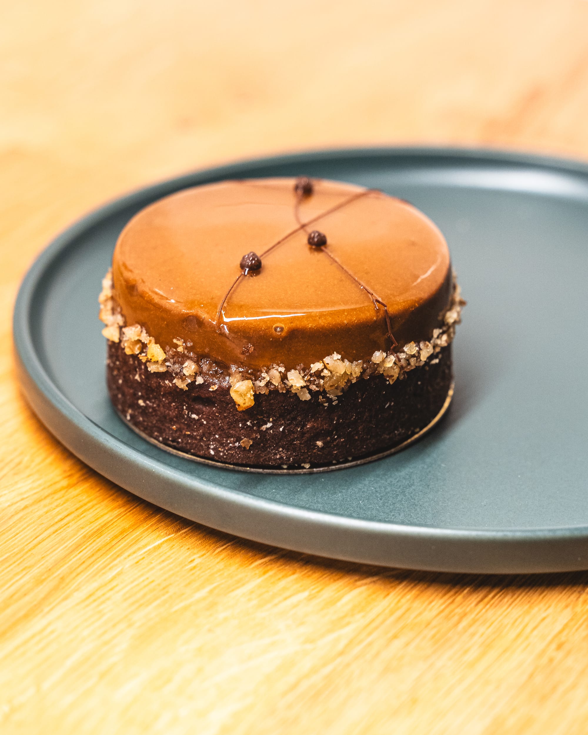 Closeup of chocolate tart with pistachio and cream layer on top