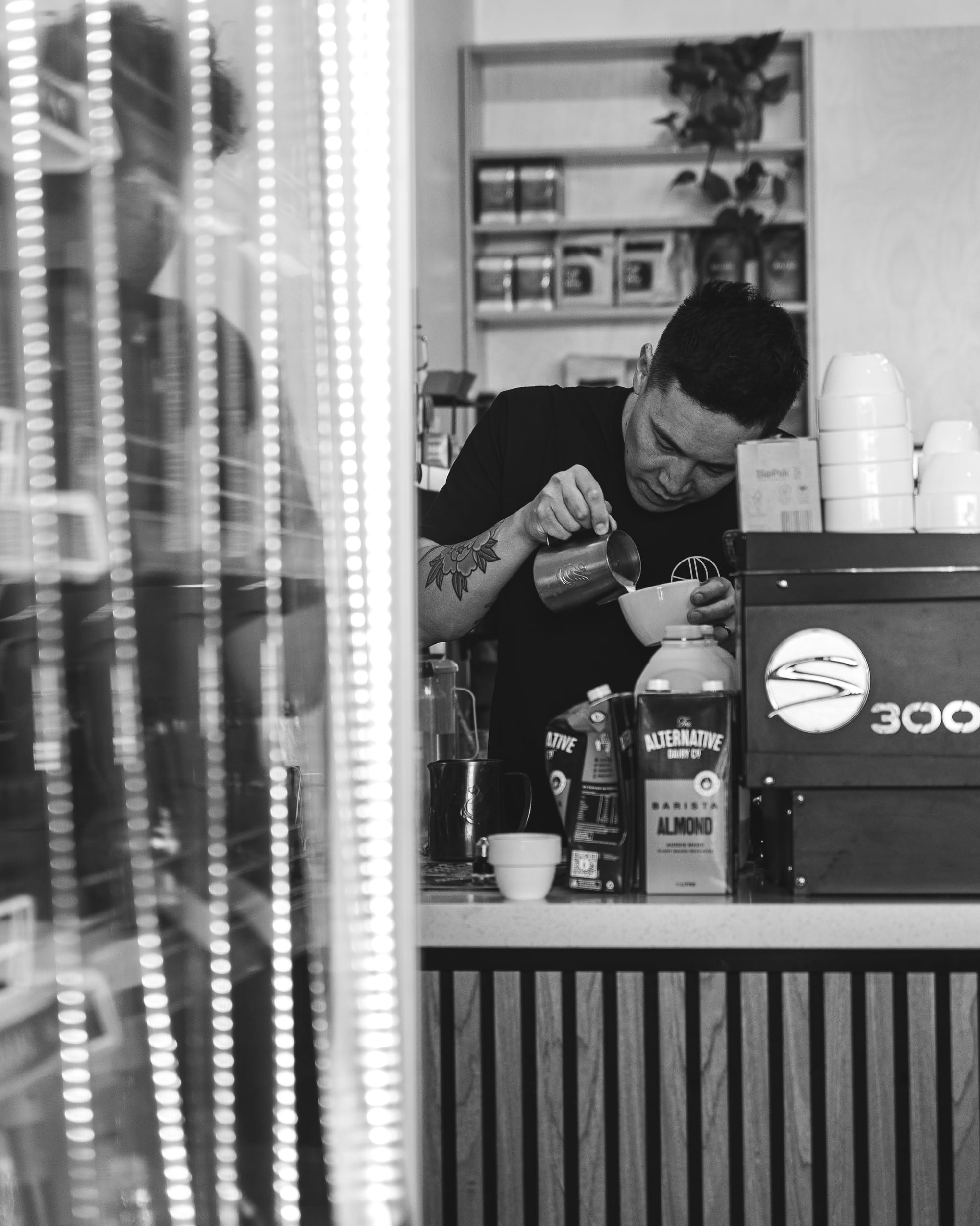 Shot of barista pouring latte art