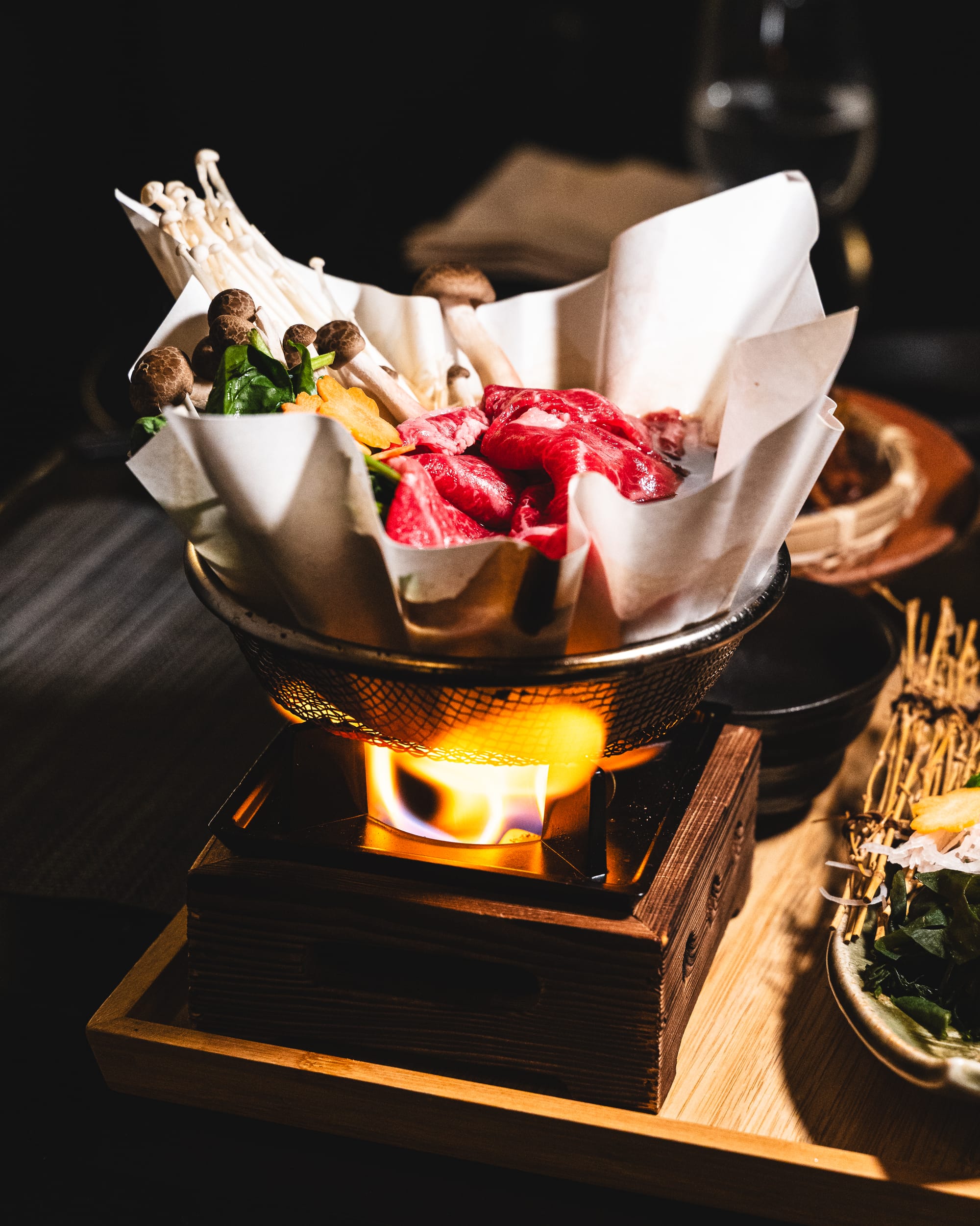 Close up of sukiyaki in pot with flame