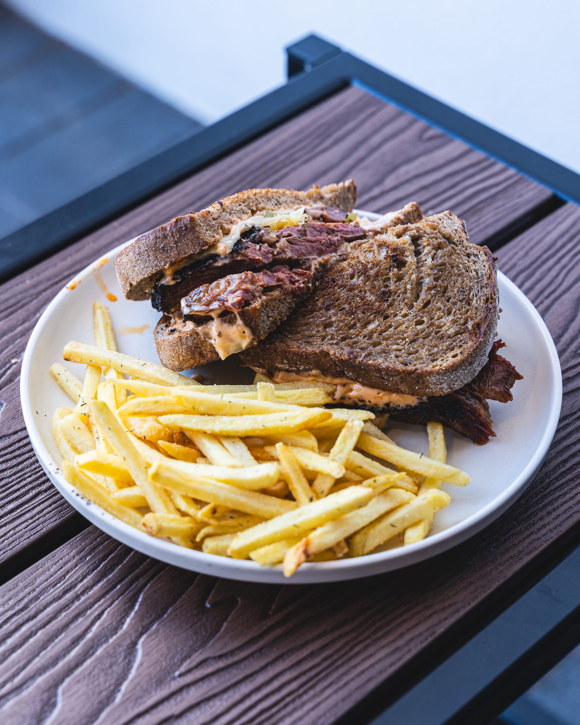 Close up of Reuben sandwich with French fries