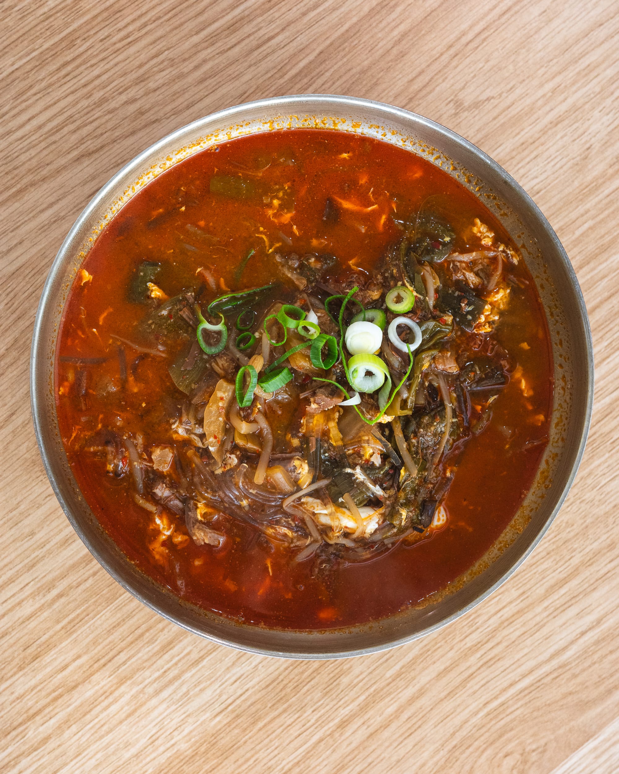 Top down shot of Korean spicy beef soup