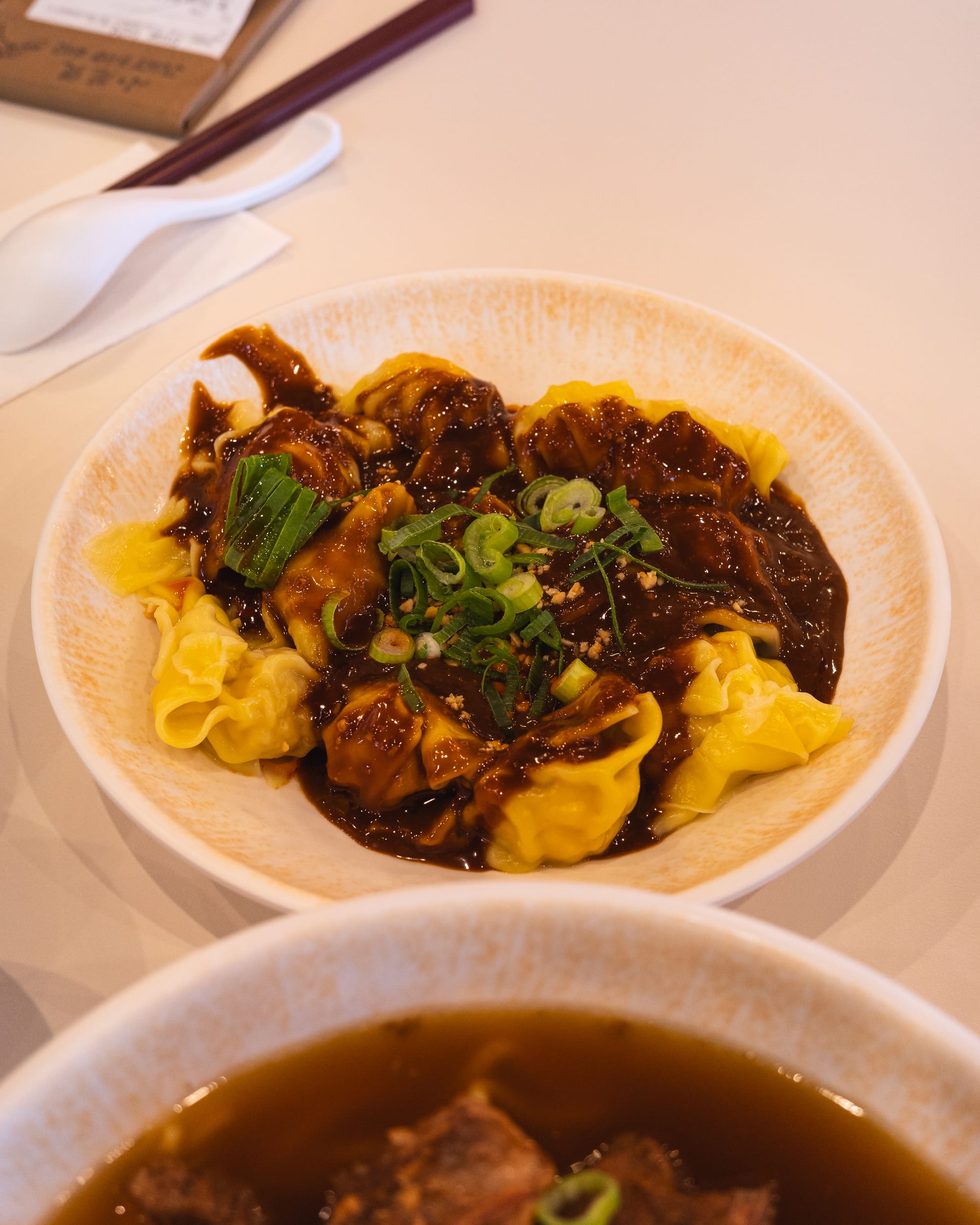 Close up of wontons in peanut sauce