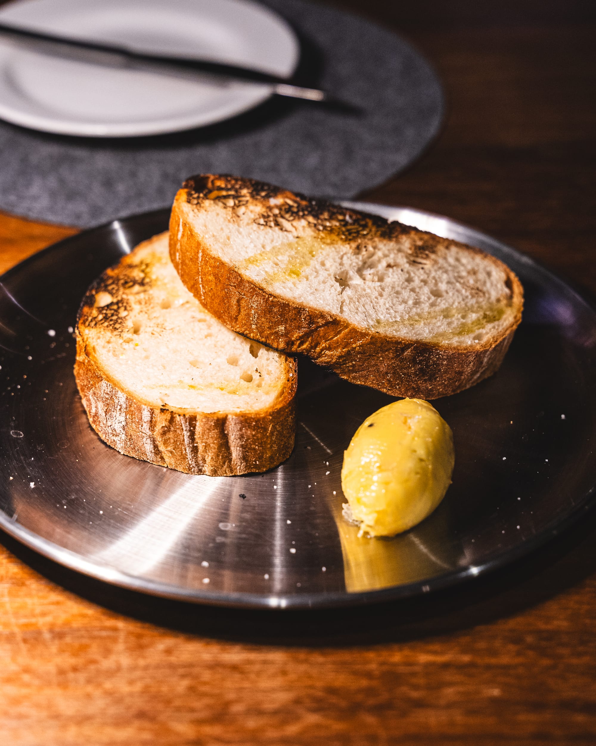 Close up of sliced bread with a quenelle of butter