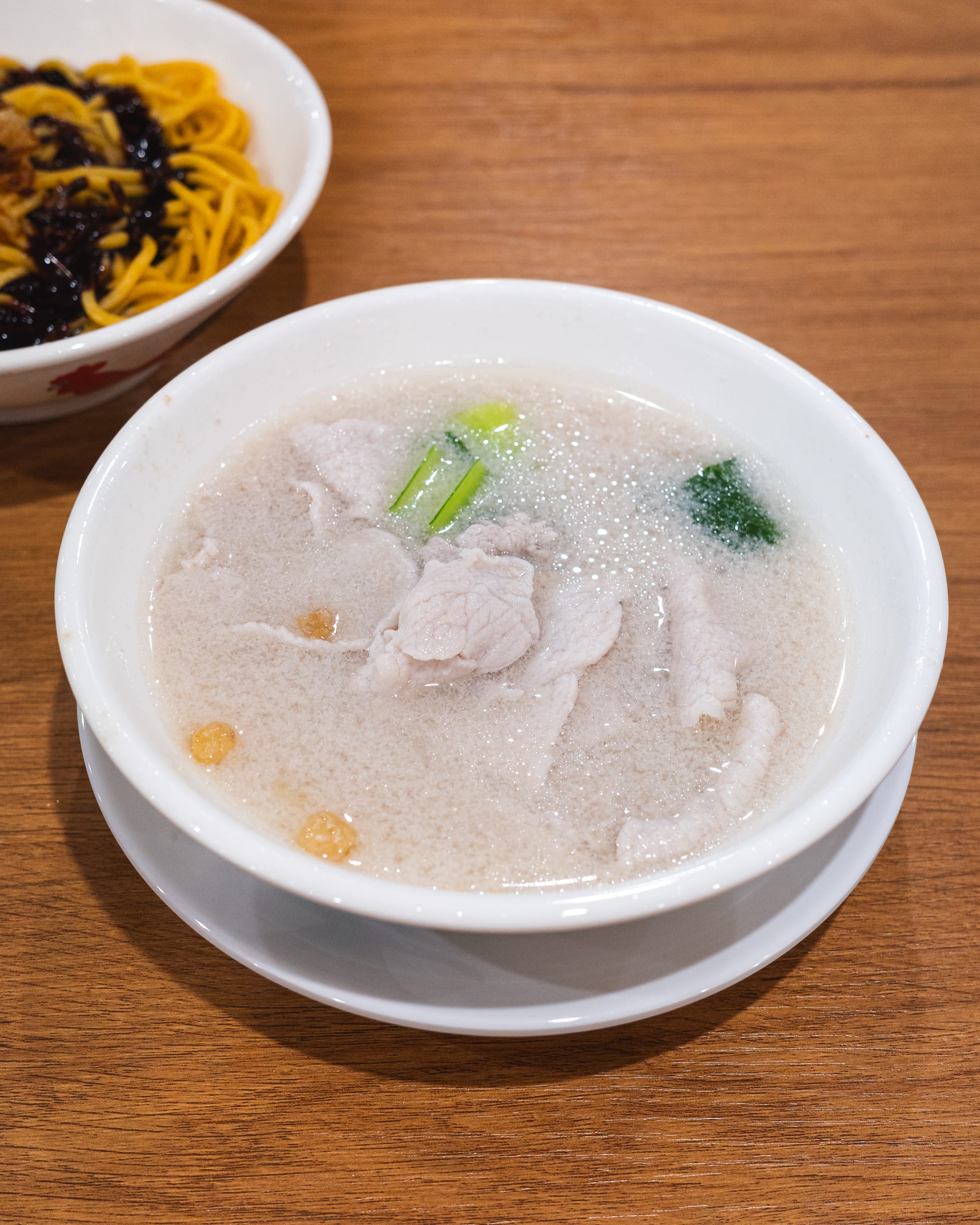 Close up of pork soup with vegetables and pork lard