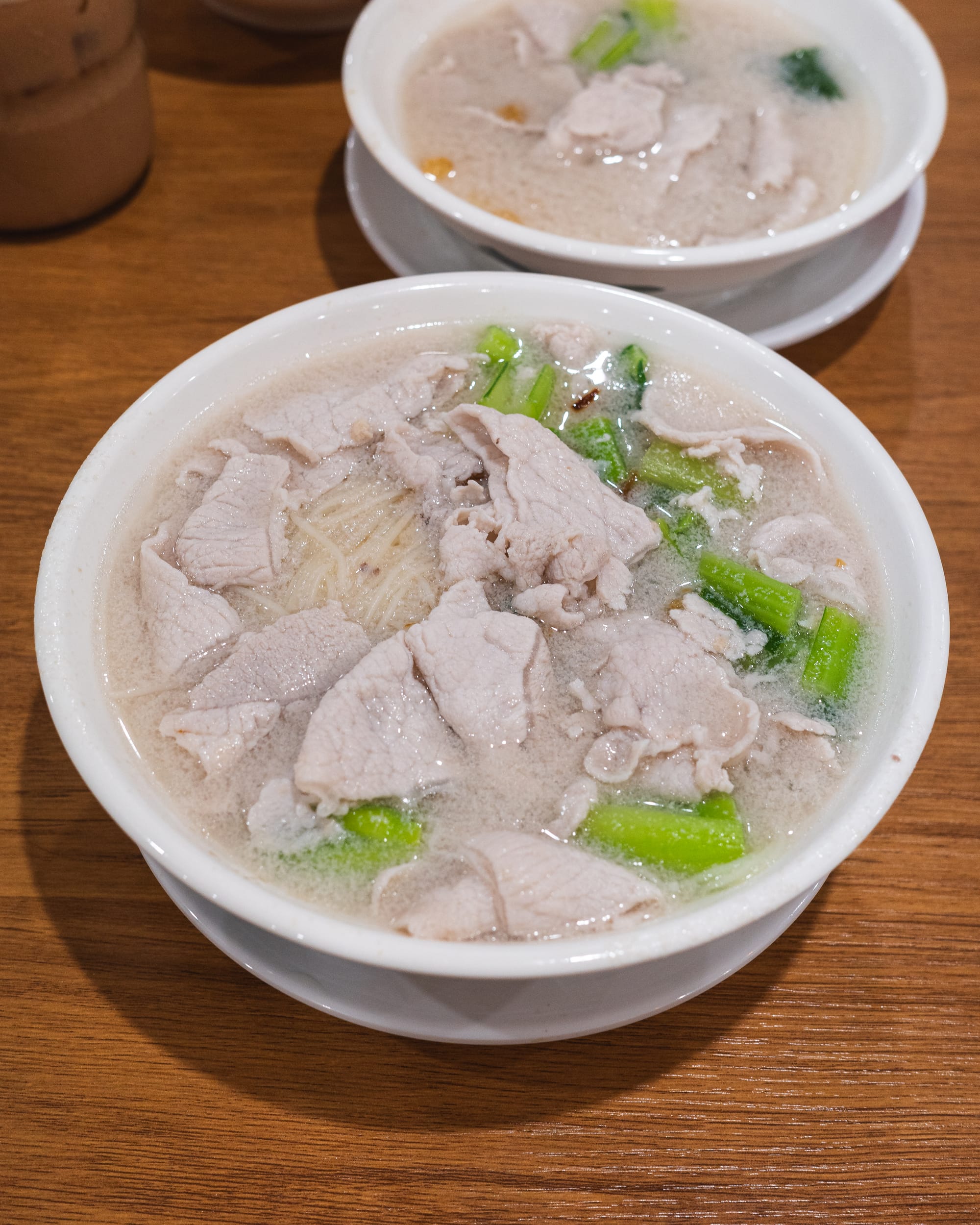 Close up of pork soup with vegetables and pork lard and noodles