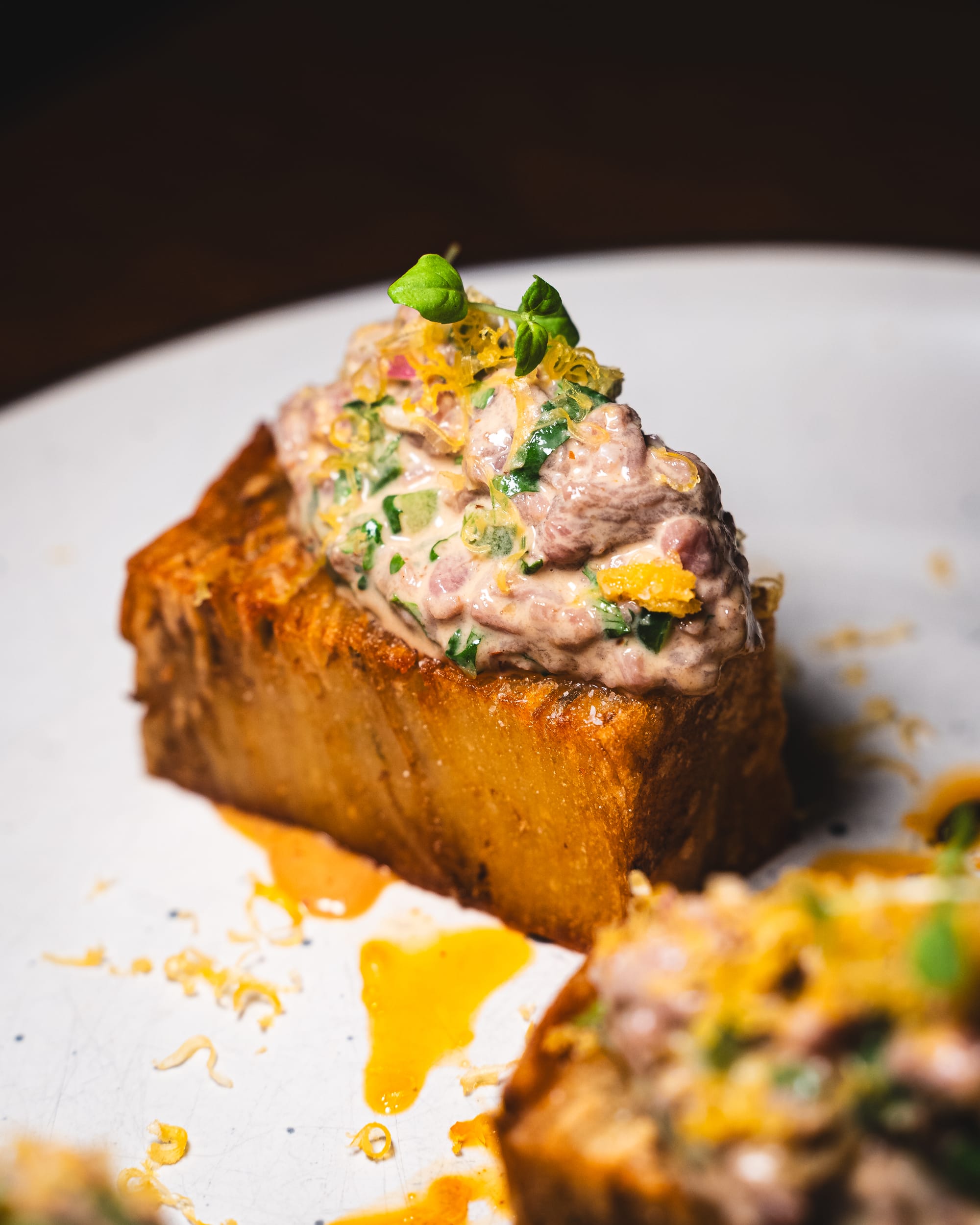 Closer up of beef tartare served on top of potato pave